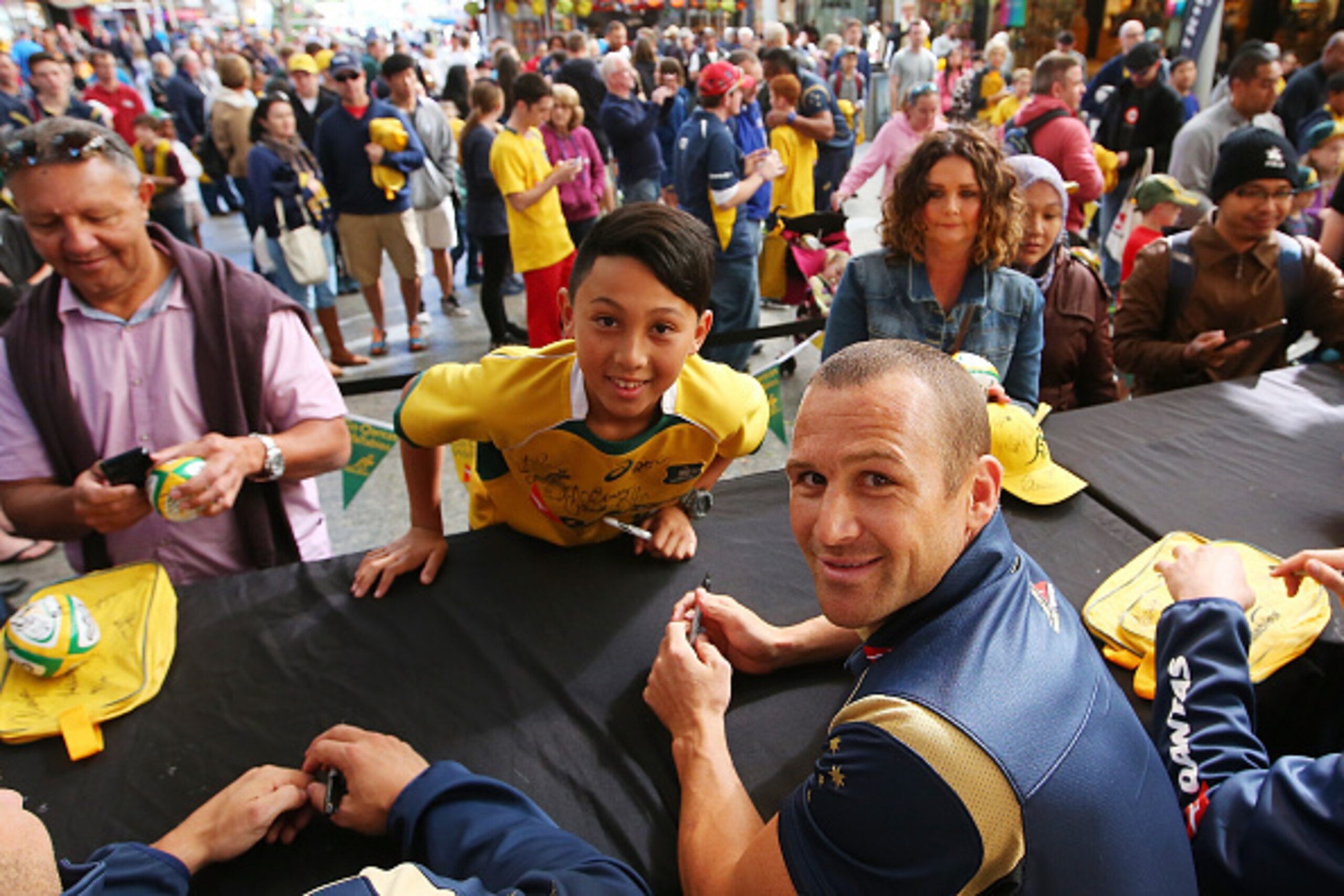 BRISBANE, AUSTRALIA - JULY 12:  Matt Giteau poses with a fan during an Australian Wallabies Fan Day at the Queen St Mall Stage on July 12, 2015 in Brisbane, Australia.  (Photo by Chris Hyde/Getty Images)