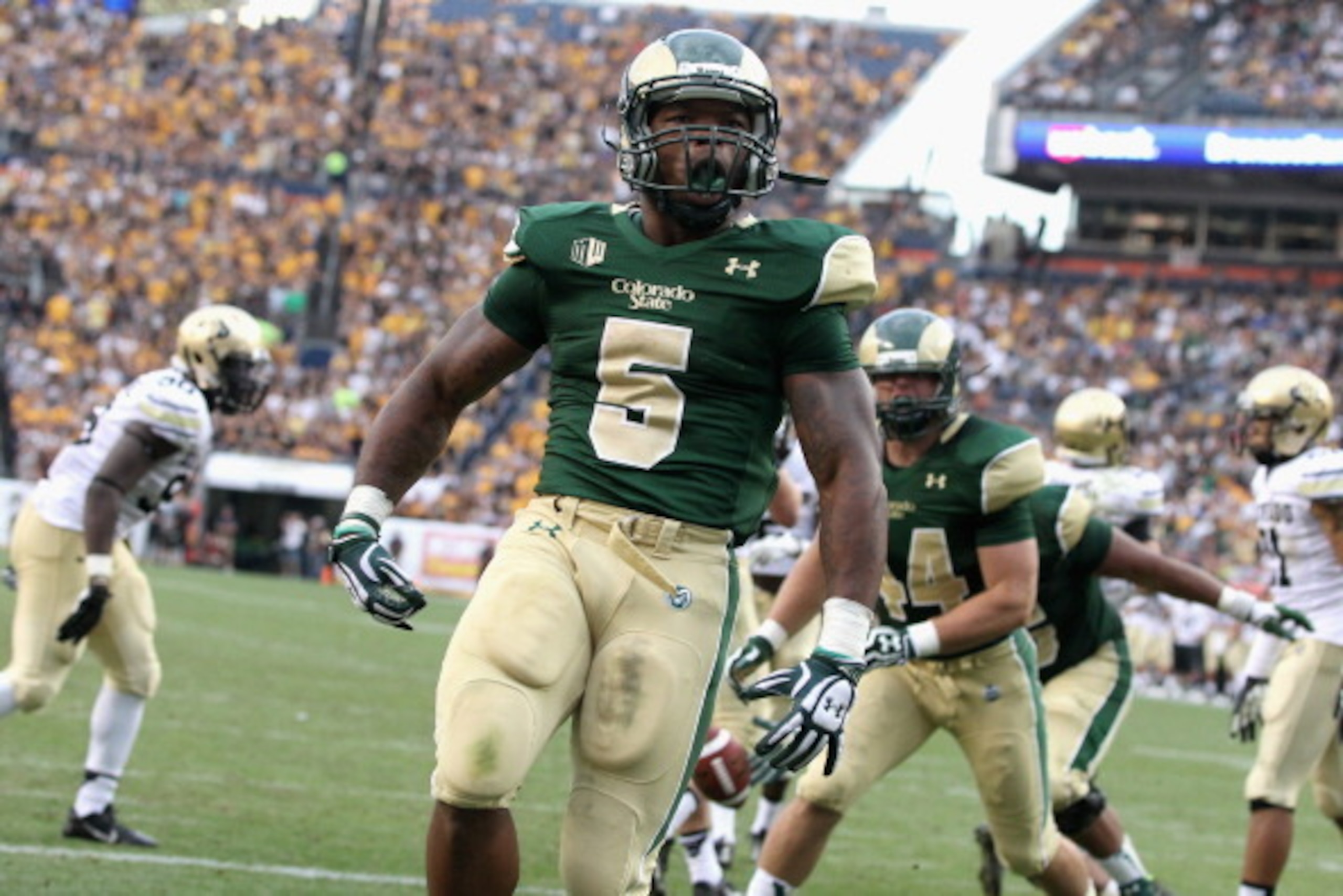 DENVER, CO - SEPTEMBER 01:  Running back Kapri Bibbs #5 of the Colorado State Rams celebrates his two yard touchdown run against the Colorado Buffaloes as the Rams took a 24-23 lead in the third quarter of the 2013 Rocky Mountain Showdown at Sports Author
