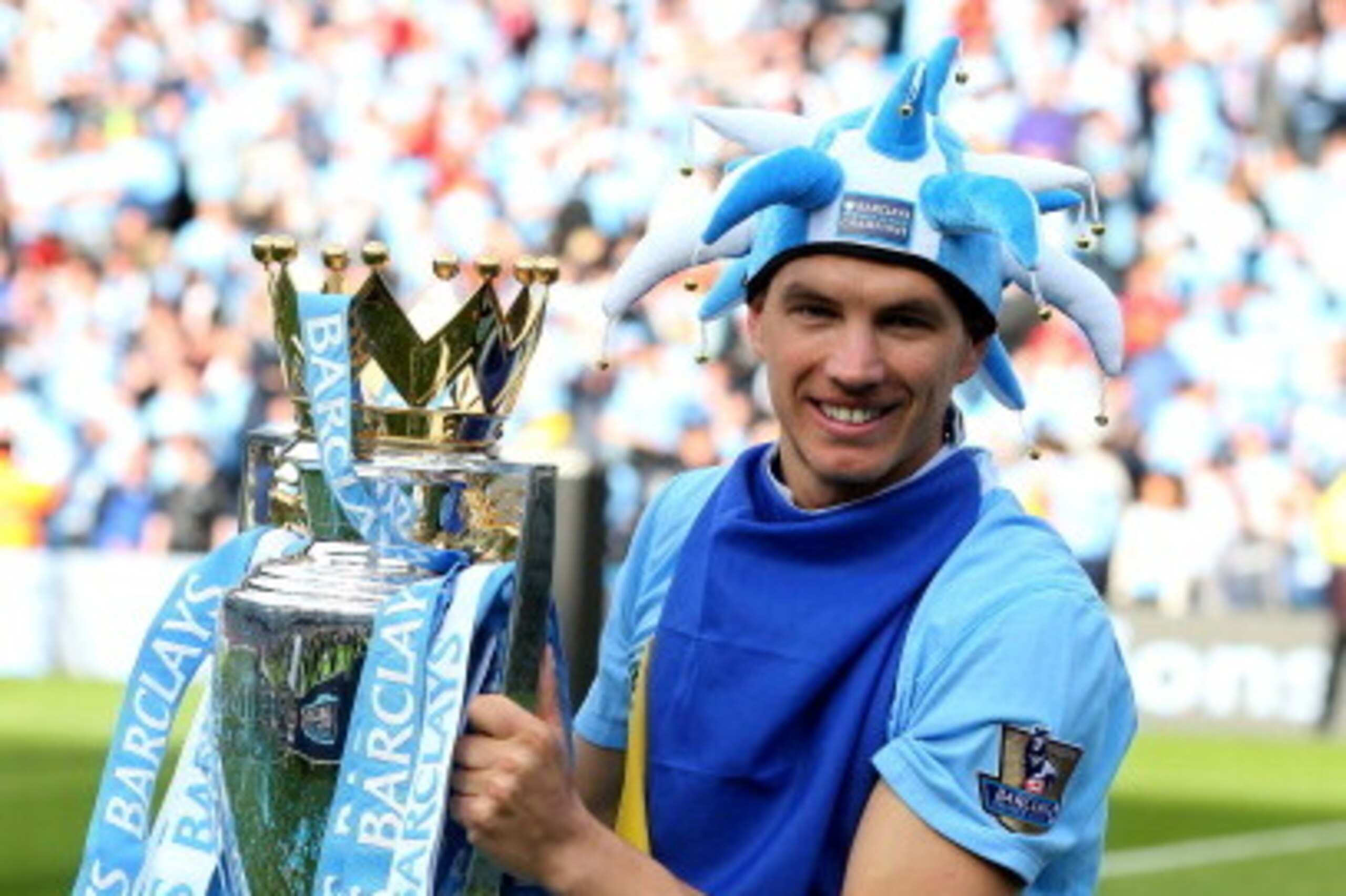 MANCHESTER, ENGLAND - MAY 13:  Edin Dzeko of Manchester City poses with the trophy following the Barclays Premier League match between Manchester City and Queens Park Rangers at the Etihad Stadium on May 13, 2012 in Manchester, England.  (Photo by Alex Li