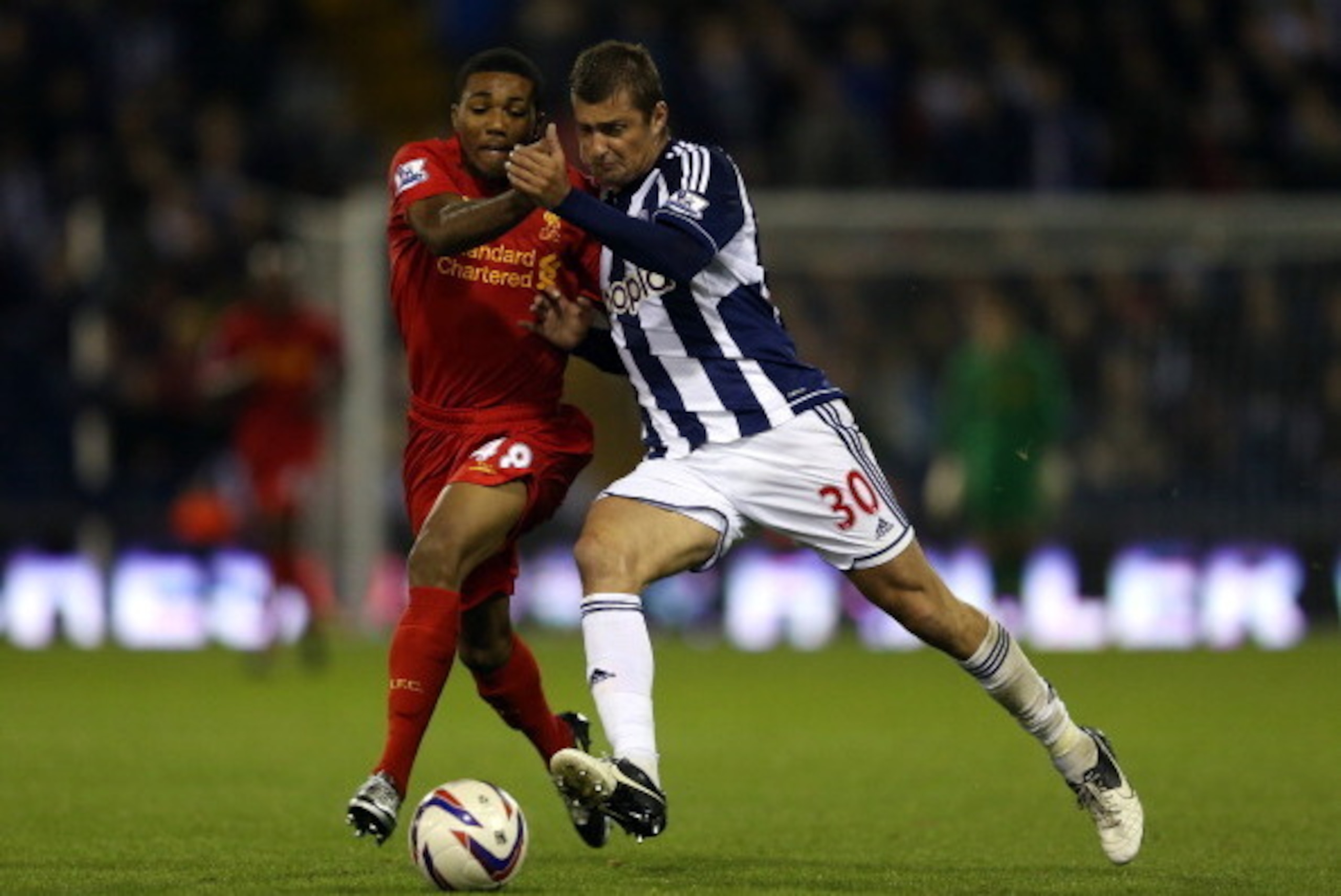 WEST BROMWICH, ENGLAND - SEPTEMBER 26: Jerome Sinclair of Liverpool battles with Gabriel Tamas of West Brom during the Capital One Cup third round match between West Bromwich Albion and Liverpool at The Hawthorns on September 26, 2012 in West Bromwich, E WEST BROMWICH, ENGLAND - SEPTEMBER 26: Jerome Sinclair of Liverpool battles with Gabriel Tamas of West Brom during the Capital One Cup third round match between West Bromwich Albion and Liverpool at The Hawthorns on September 26, 2012 in West Bromwich, E