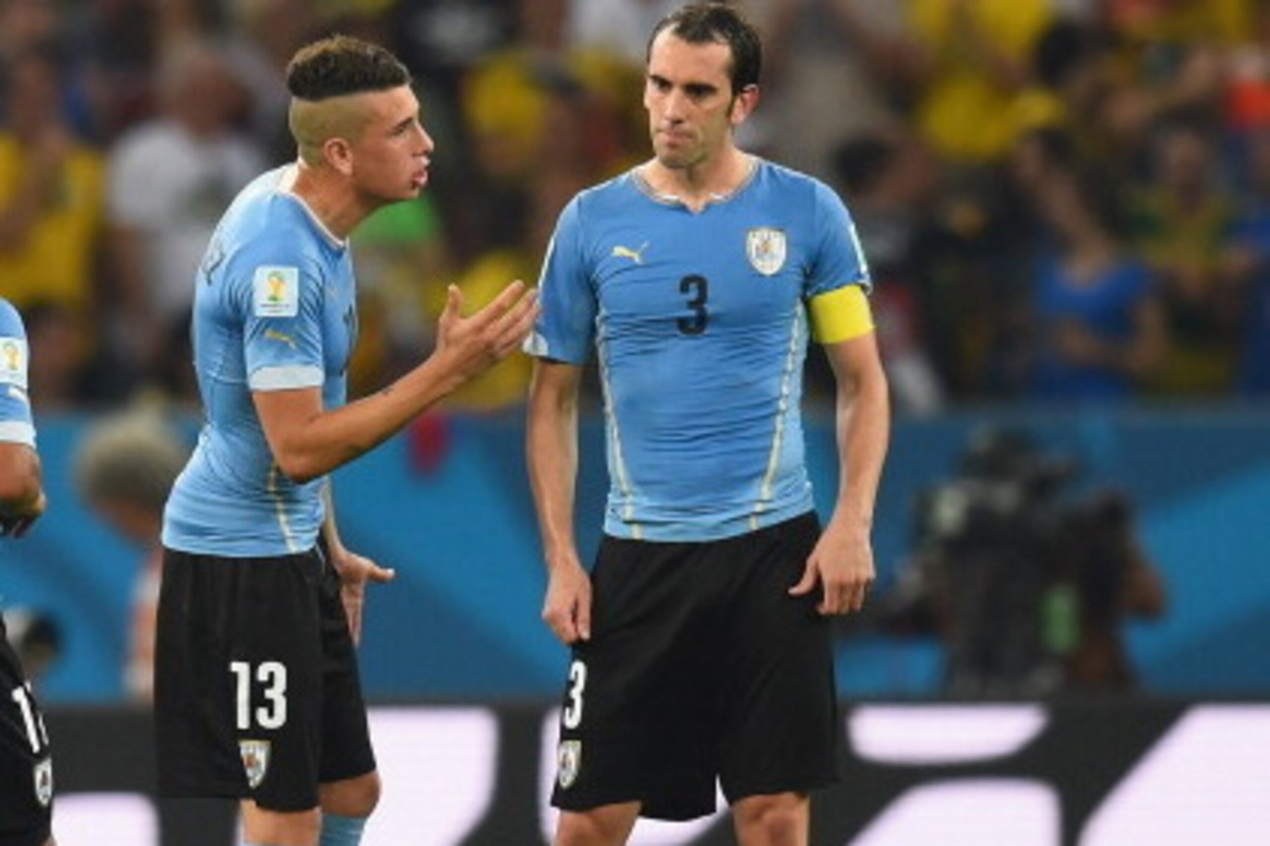 RIO DE JANEIRO, BRAZIL - JUNE 28:  Jose Gimenez and Diego Godin of Uruguay speak during the 2014 FIFA World Cup Brazil round of 16 match between Colombia and Uruguay at Maracana on June 28, 2014 in Rio de Janeiro, Brazil.  (Photo by Matthias Hangst/Getty 