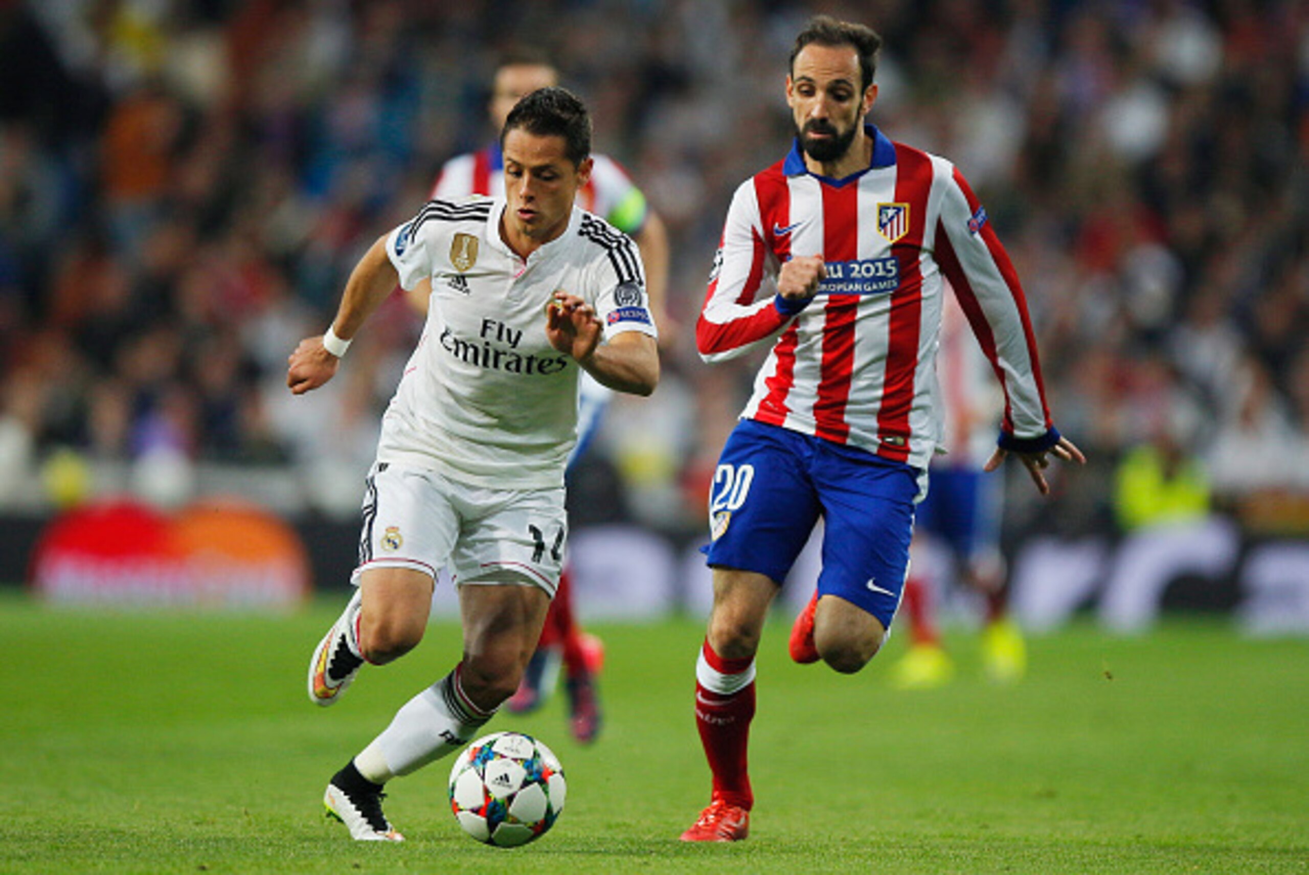 MADRID, SPAIN - APRIL 22:  Javier Hernandez of Real Madrid CF is chased by Juanfran of Atletico Madrid during the UEFA Champions League quarter-final second leg match between Real Madrid CF and Club Atletico de Madrid at Bernabeu on April 22, 2015 in Madr