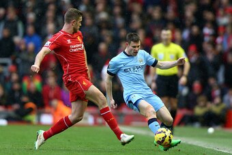 LIVERPOOL, ENGLAND - MARCH 01:  James Milner of Manchester City is closed down by Jordan Henderson of Liverpool during the Barclays Premier League match between Liverpool and Manchester City at Anfield on March 1, 2015 in Liverpool, England.  (Photo by Cl