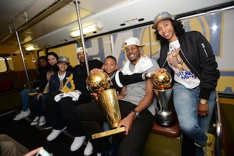 OAKLAND, CA - JUNE 19: Andre Iguodala #9 of the Golden State Warriors celebrates winning the Bill Russell Finals MVP award and the 2015 NBA Championship with his family during a parade on June 19, 2015 in Oakland, CA.  NOTE TO USER: User expressly acknowl