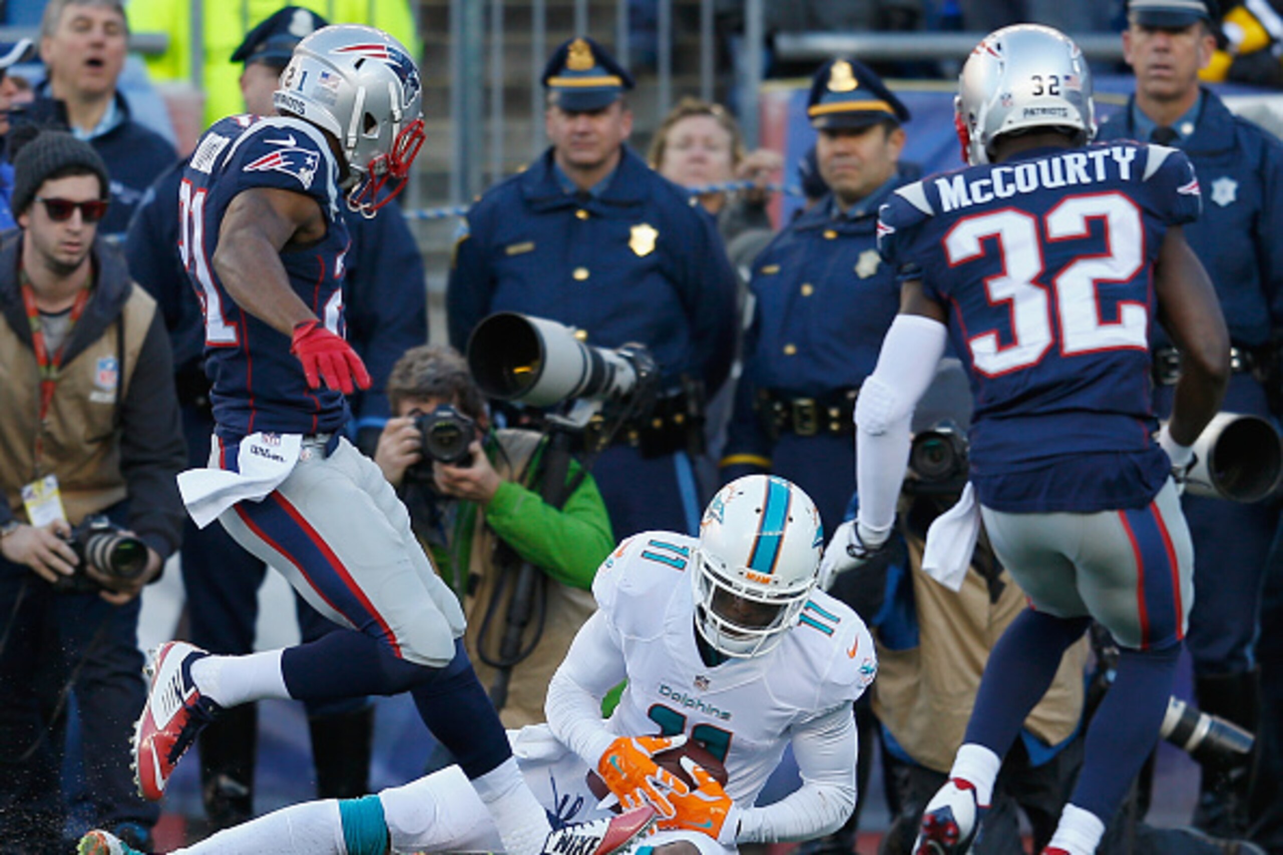 FOXBORO, MA - DECEMBER 14:  Mike Wallace #11 of the Miami Dolphins catches a touchdown pass as Malcolm Butler #21 of the New England Patriots defends during the second quarter at Gillette Stadium on December 14, 2014 in Foxboro, Massachusetts.  (Photo by 