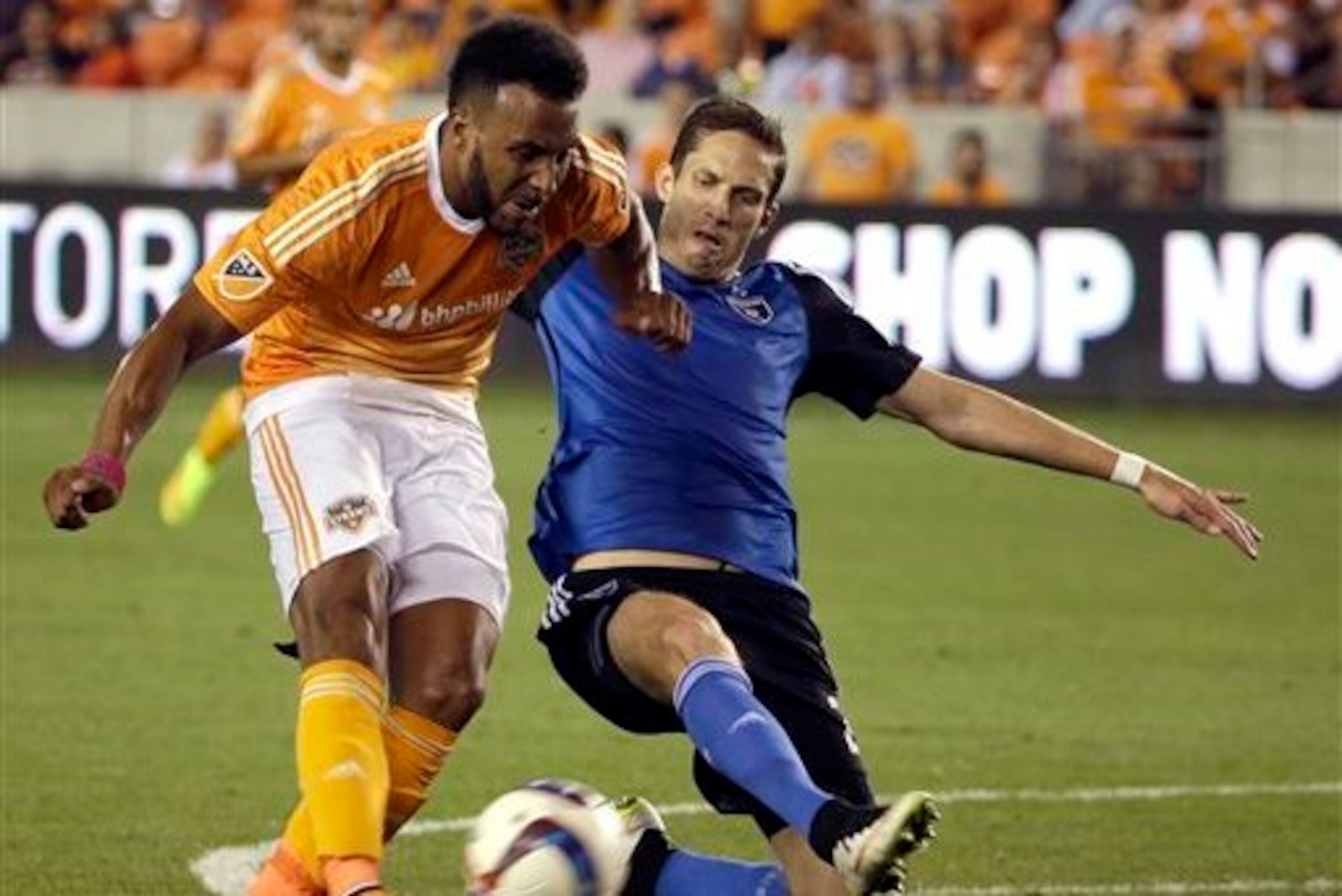 San Jose Earthquakes' Clarence Goodson (right) challenging Houston Dynamo's Giles Barnes (left).