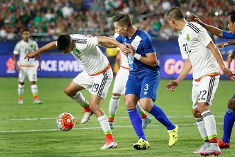 GLENDALE, AZ - JULY 12:  Oribe Peralta #19 of Mexico attempts to control the ball under pressure from Elias Enoc Vasquez #3 of Guatemala during the 2015 CONCACAF Gold Cup group C match at University of Phoenix Stadium on July 12, 2015 in Glendale, Arizona