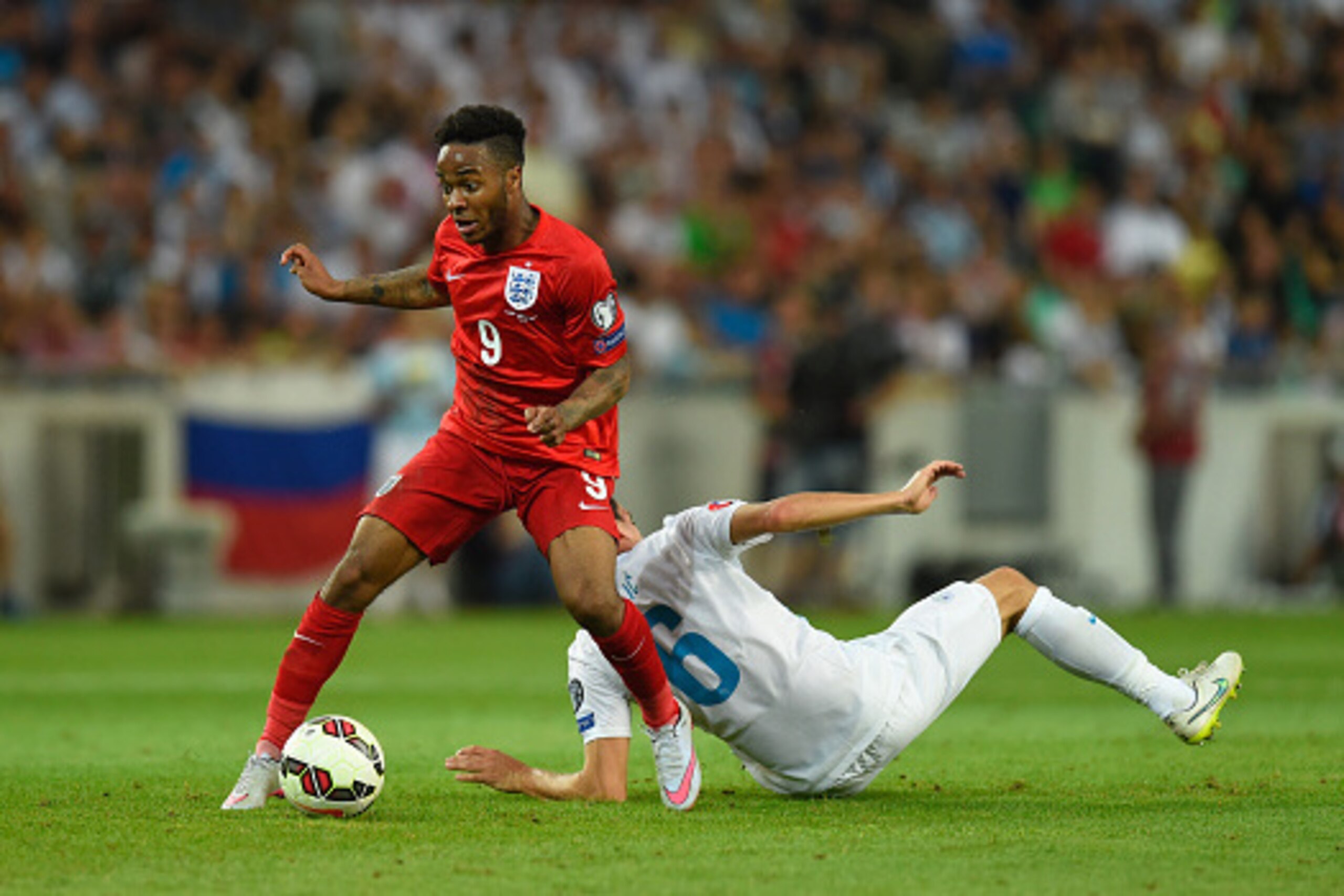 LJUBLJANA, SLOVENIA - JUNE 14:  England player Raheem Sterling skips past Branko Ilic of Slovenia during the UEFA EURO 2016 Qualifier between Slovenia and England on at the Stozice Arena on June 14, 2015 in Ljubljana, Slovenia.  (Photo by Stu Forster/Gett
