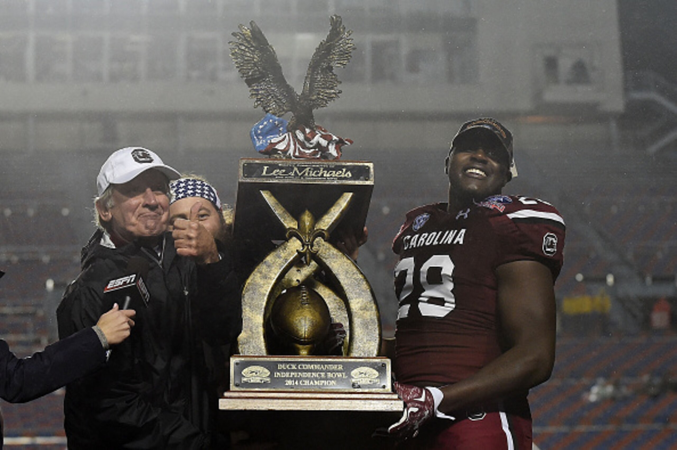 SHREVEPORT, LA - DECEMBER 27:  Head coach Steve Spurrier of the South Carolina Gamecocks raises the trophy with Jonathan Walton #28 following a victory over the Miami Hurricanes at the Duck Commander Independence Bowl at Independence Stadium on December 2