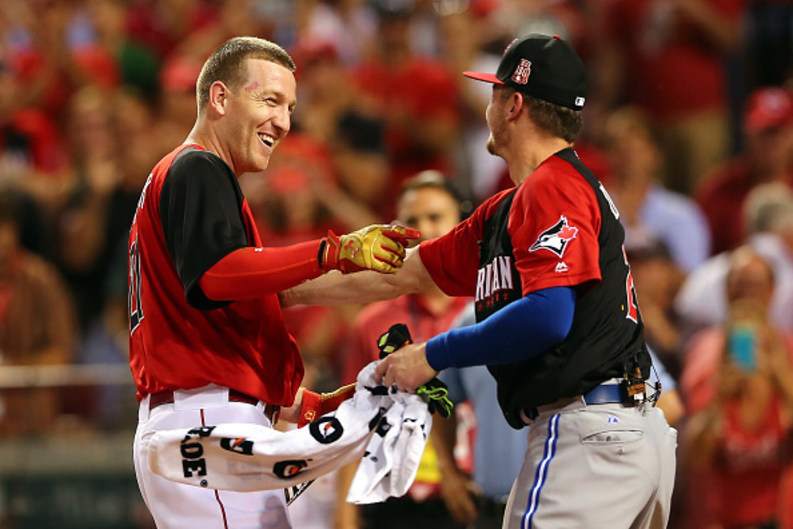 CINCINNATI, OH - JULY 13:  National League All-Star Todd Frazier #21 of the Cincinnati Reds reacts with American League All-Star Josh Donaldson #20 of the Toronto Blue Jays during the Gillette Home Run Derby presented by Head & Shoulders at the Great Amer