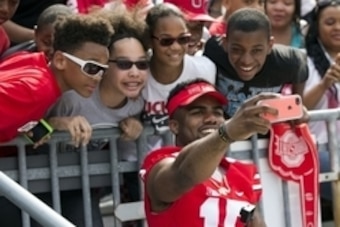 Apr 18, 2015; Columbus, OH, USA; Ohio State Buckeyes running back Ezekiel Elliott (15) takes a selfie with fans during the Ohio State Spring Game at Ohio Stadium. The Gray team won the game 17-14. Mandatory Credit: Greg Bartram-USA TODAY Sports