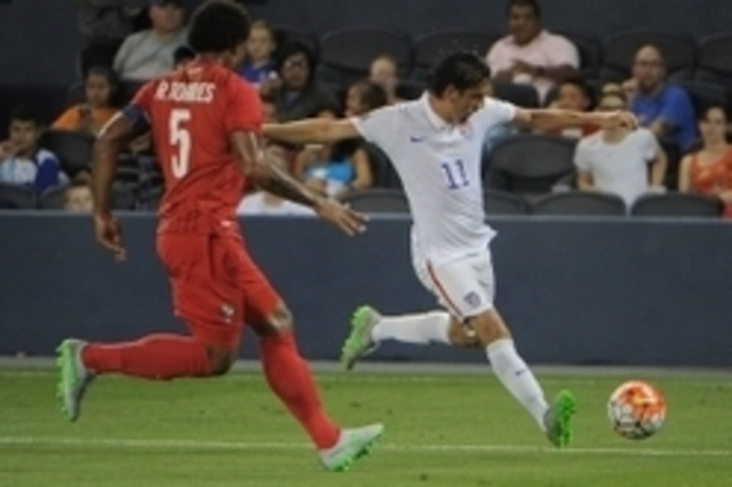 Jul 13, 2015; Kansas City, MO, USA; USA midfielder Alejandro Bedoya (11) dribbles the ball as Panama defender Roman Torres (5) chases in the second half during CONCACAF Gold Cup group play at Sporting Park. The game ended in a 1-1 tie. Mandatory Credit: J