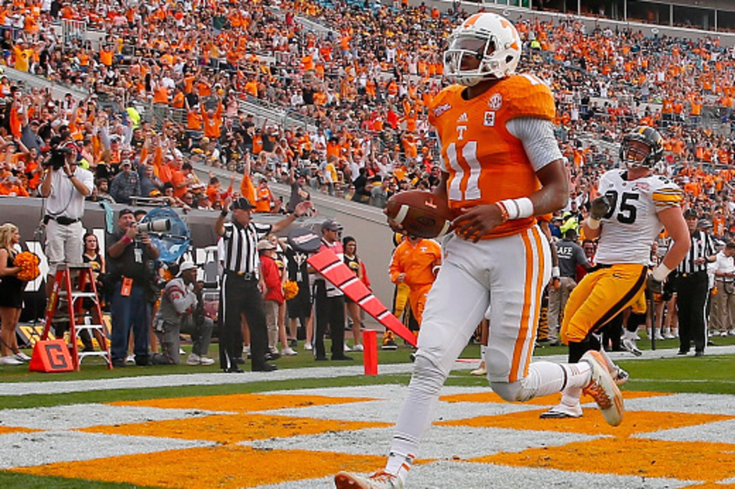 JACKSONVILLE, FL - JANUARY 02:  Joshua Dobbs #11 of the Tennessee Volunteers crosses the goal line for a touchdown during the TaxSlayer Bowl against the Iowa Hawkeyes at EverBank Field on January 2, 2015 in Jacksonville, Florida.  (Photo by Sam Greenwood/