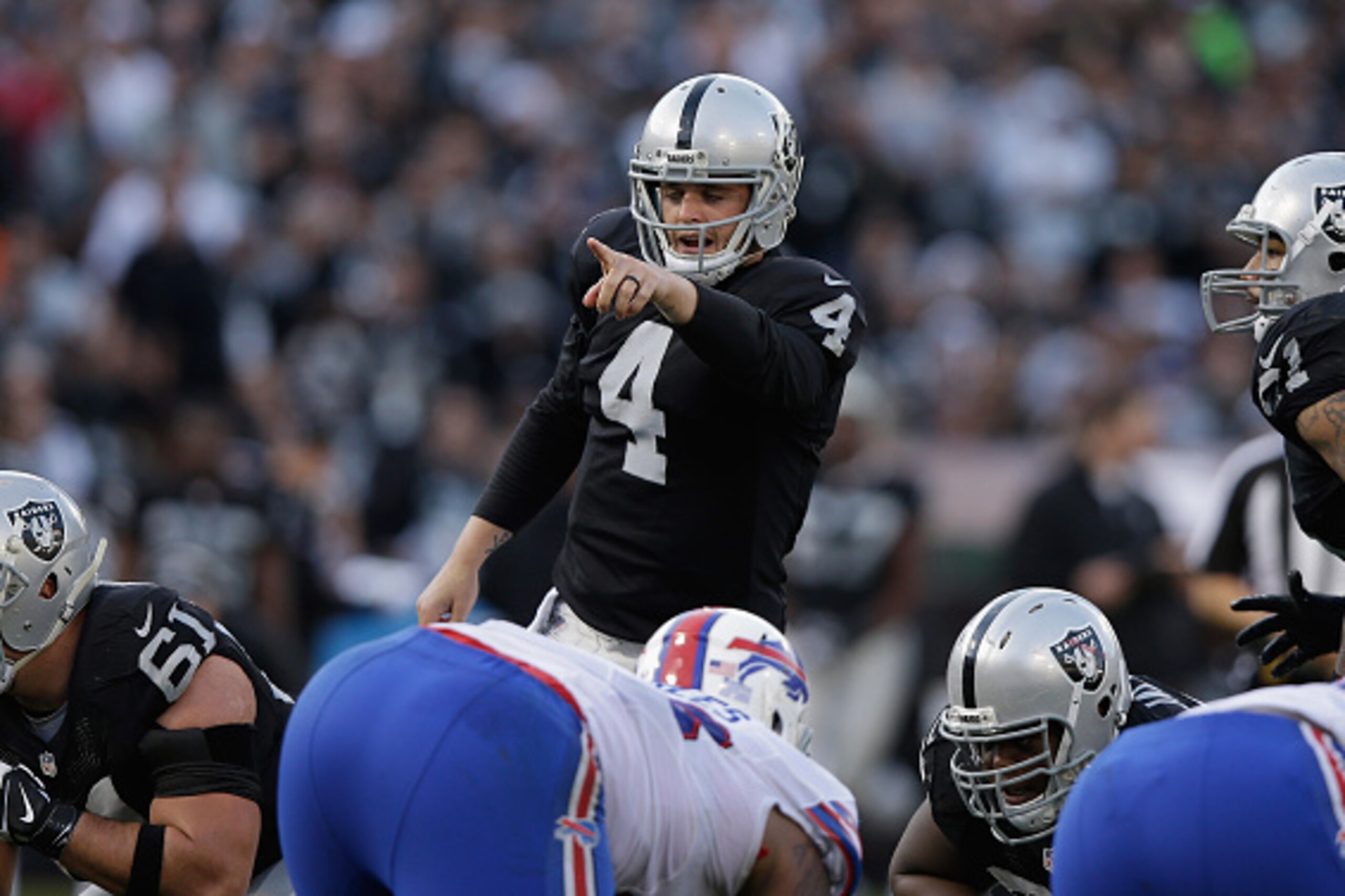 OAKLAND, CA - DECEMBER 21: Derek Carr #4 of the Oakland Raiders starts the play against the Buffalo Bills in the third quarter at O.co Coliseum on December 21, 2014 in Oakland, California.  (Photo by Ezra Shaw/Getty Images)