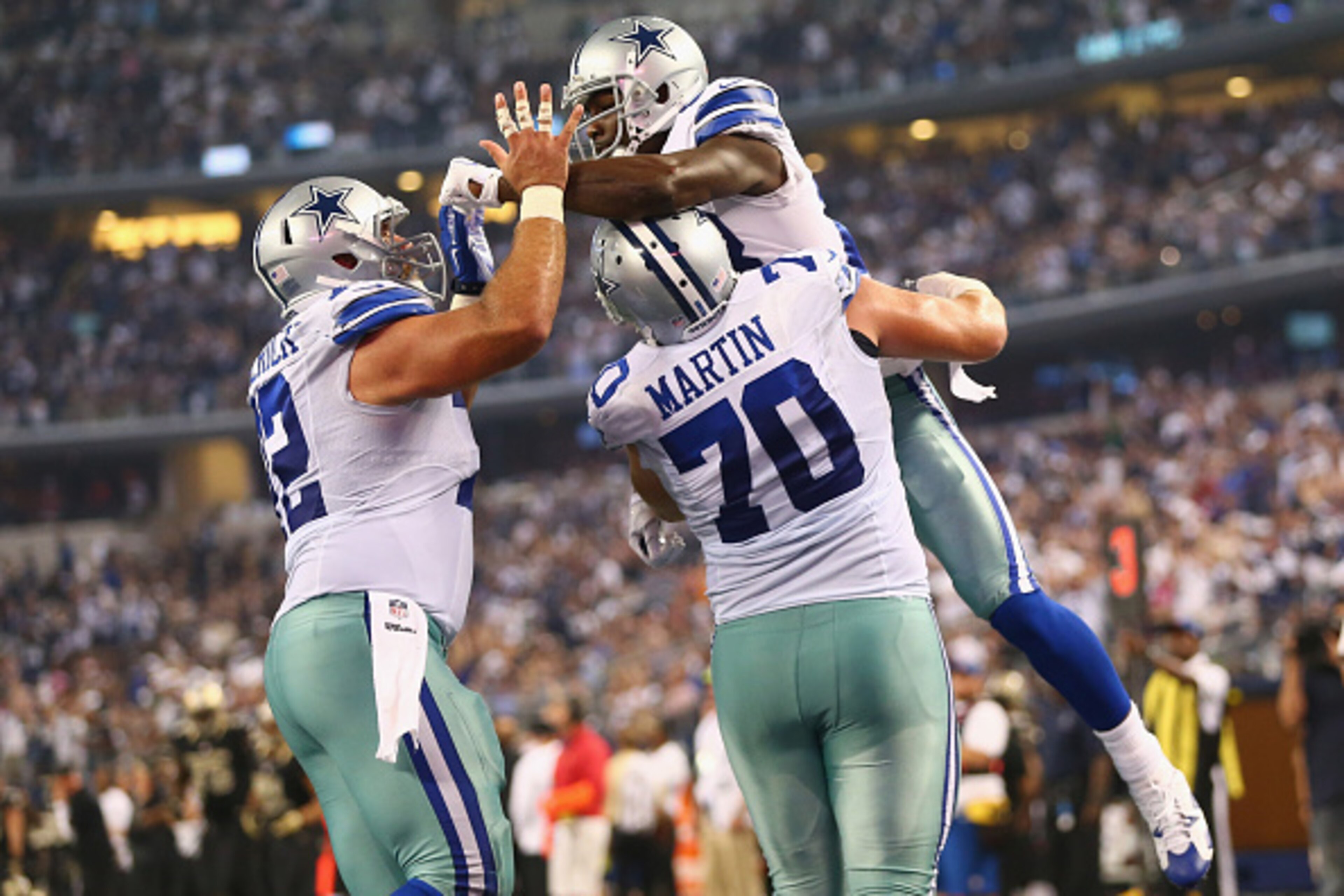 ARLINGTON, TX - SEPTEMBER 28: Dez Bryant #88 of the Dallas Cowboys celebrates a touchdown with Zack Martin #70 and Travis Frederick #72 against the New Orleans Saints at AT&T Stadium on September 28, 2014 in Arlington, Texas. (Photo by Ronald Martinez/ ARLINGTON, TX - SEPTEMBER 28: Dez Bryant #88 of the Dallas Cowboys celebrates a touchdown with Zack Martin #70 and Travis Frederick #72 against the New Orleans Saints at AT&T Stadium on September 28, 2014 in Arlington, Texas. (Photo by Ronald Martinez/