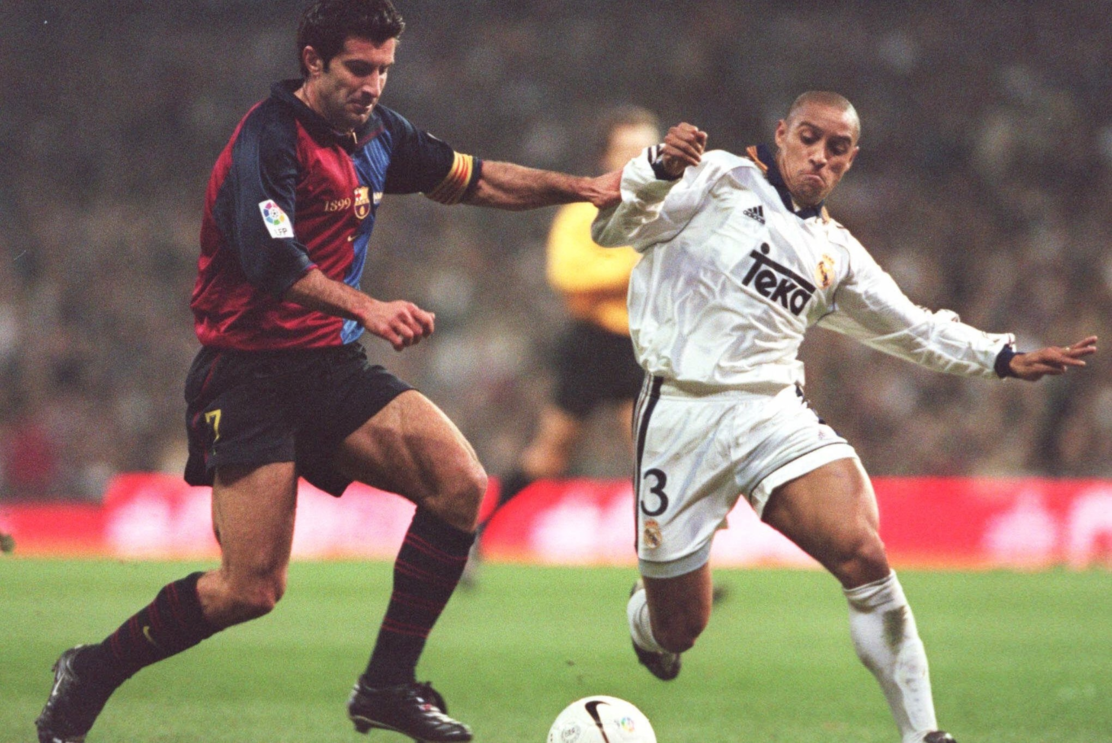 Figo in action for Barca against Madrid's Roberto Carlos Figo in action for Barca against Madrid's Roberto Carlos
