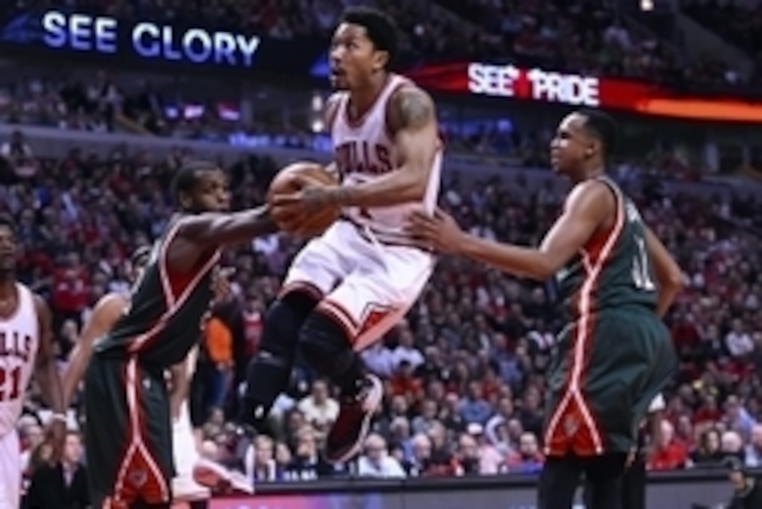 Apr 20, 2015; Chicago, IL, USA; Chicago Bulls guard Derrick Rose (1) shoots the ball against Milwaukee Bucks center John Henson (31) and guard Khris Middleton (22) during the second half in game two of the first round of the 2015 NBA Playoffs at the Unite
