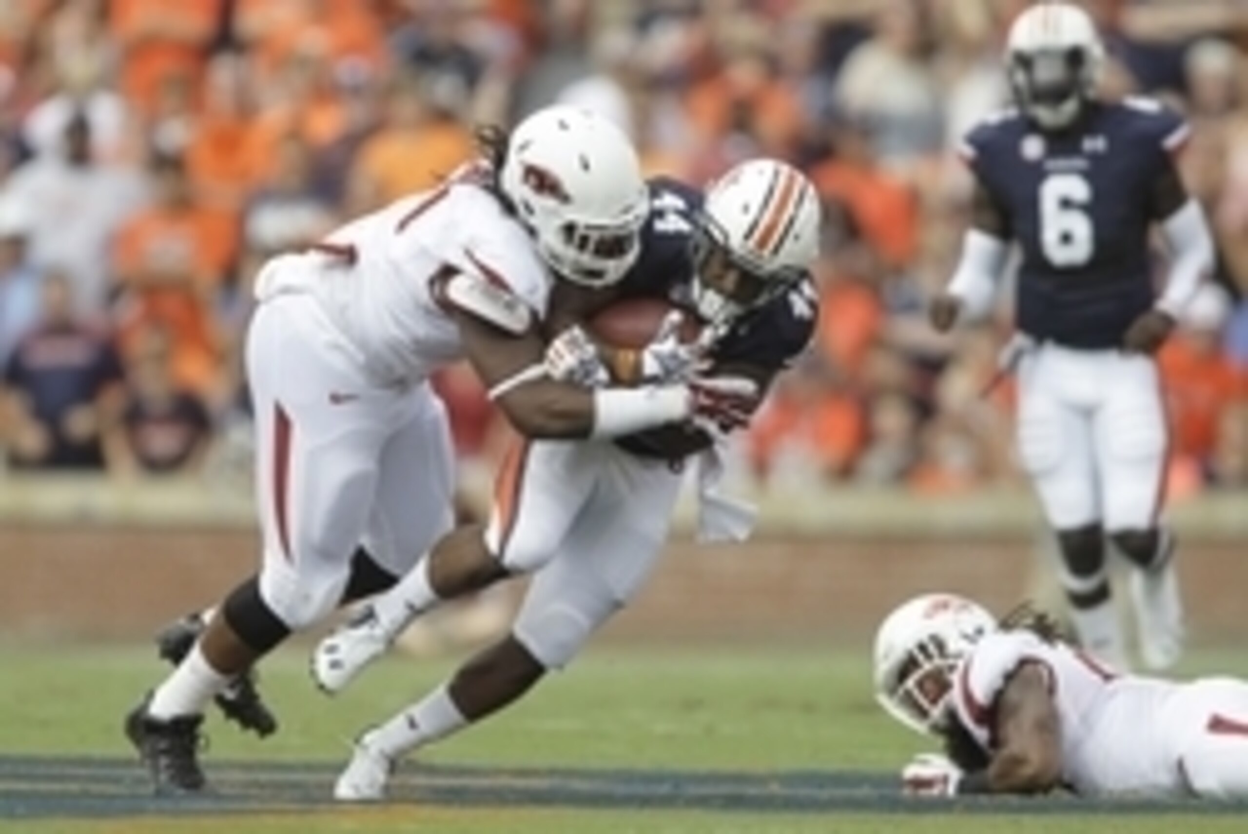 Aug 30, 2014; Auburn, AL, USA;  Auburn Tigers running back Cameron Artis-Payne (44) is tackled by Arkansas Razorbacks tackle Darius Philon (91) during the first half at Jordan Hare Stadium. Mandatory Credit: John Reed-USA TODAY Sports