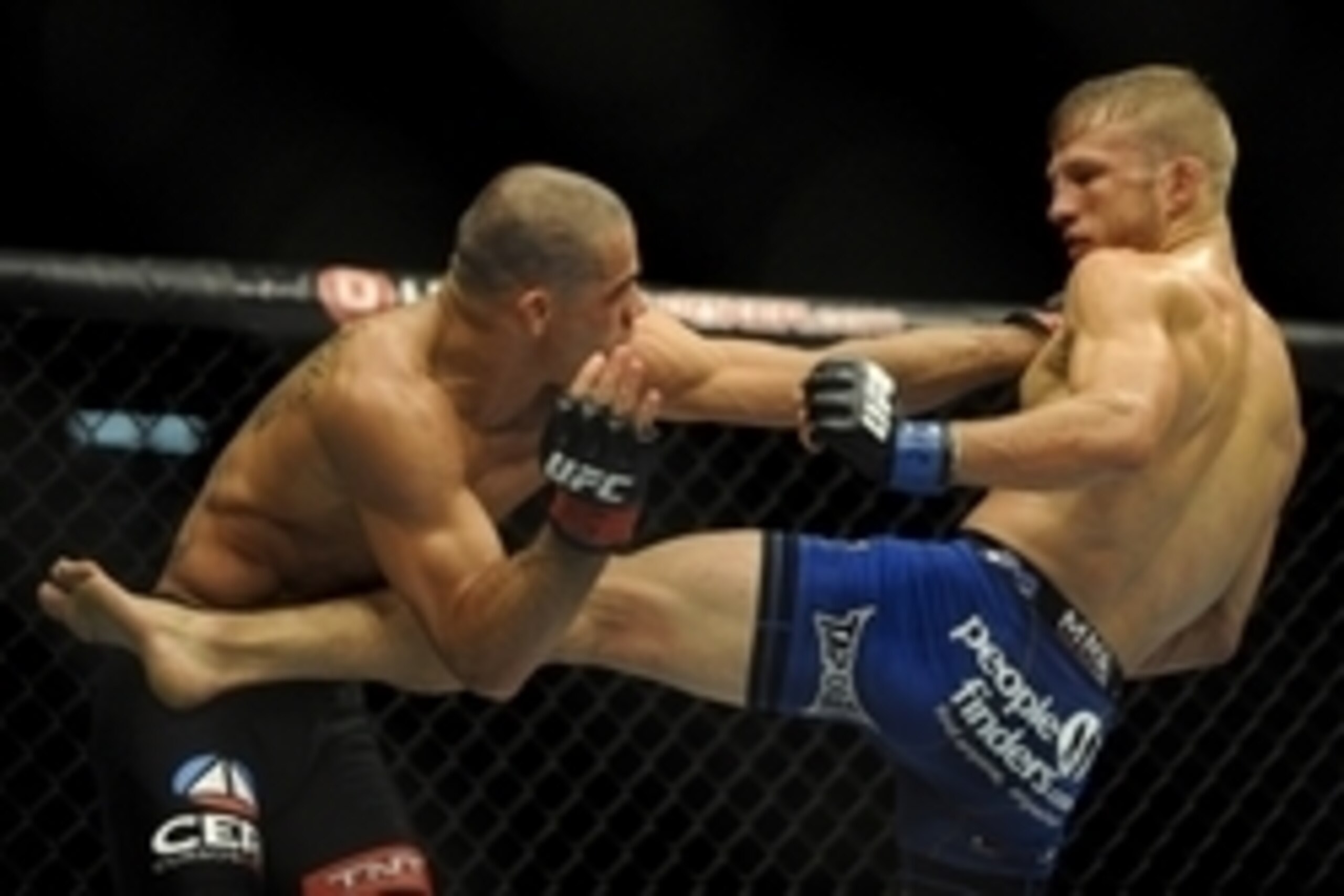 May 24, 2014; Las Vegas, NV, USA;   TJ Dillashaw (blue) lands a kick on Renan Barao (red) during their UFC 173 bantamweight championship bout at MGM Grand Garden Arena. Dillashaw won the bout by way of TKO. Mandatory Credit: Stephen R. Sylvanie-USA TODAY 