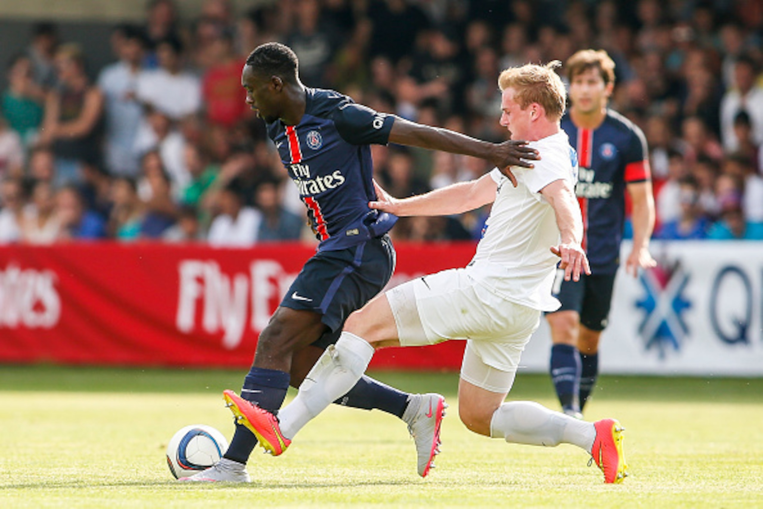 VIENNA, AUSTRIA - JULY 12:  Jean-Kevin Augustin of Paris Saint-Germain (L) competes for the ball with Daniel Seper of Wiener Sportklub during the Friendly Match between Wiener Sportklub and Paris Saint-Germain at Sportclub Platz on July 12, 2015 in Vienna