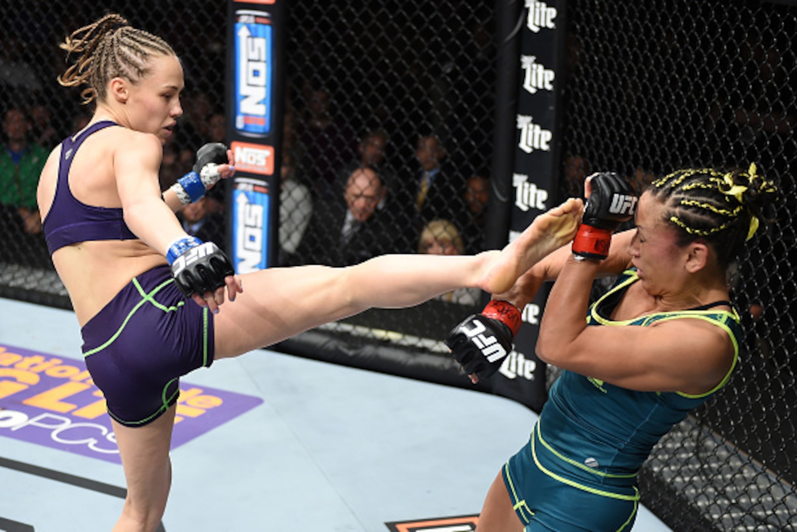 LAS VEGAS, NEVADA - DECEMBER 12: (L-R) Rose Namajunas kicks Carla Esparza in their strawweight championship fight during The Ultimate Fighter Finale event inside the Pearl concert theater at the Palms Casino Resort on December 12, 2014 in Las Vegas, Nevad