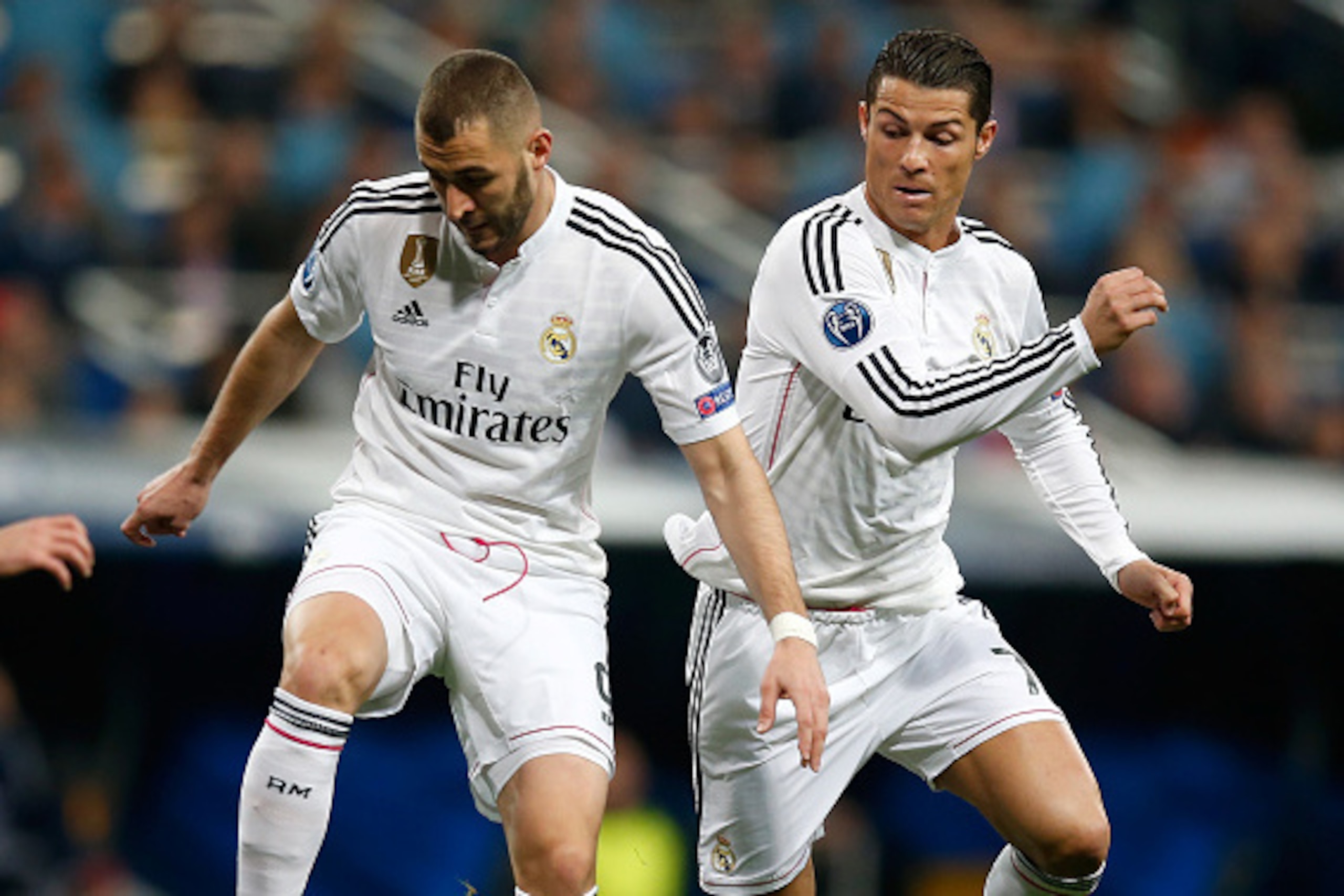 MADRID, SPAIN - MARCH 10:  Karim Benzema (L) and team mate Cristiano Ronaldo (R) of Real Madrid control the ball during the UEFA Champions League Round of 16 second leg match between Real Madrid CF and FC Schalke 04 at Estadio Santiago Bernabeu on March 1