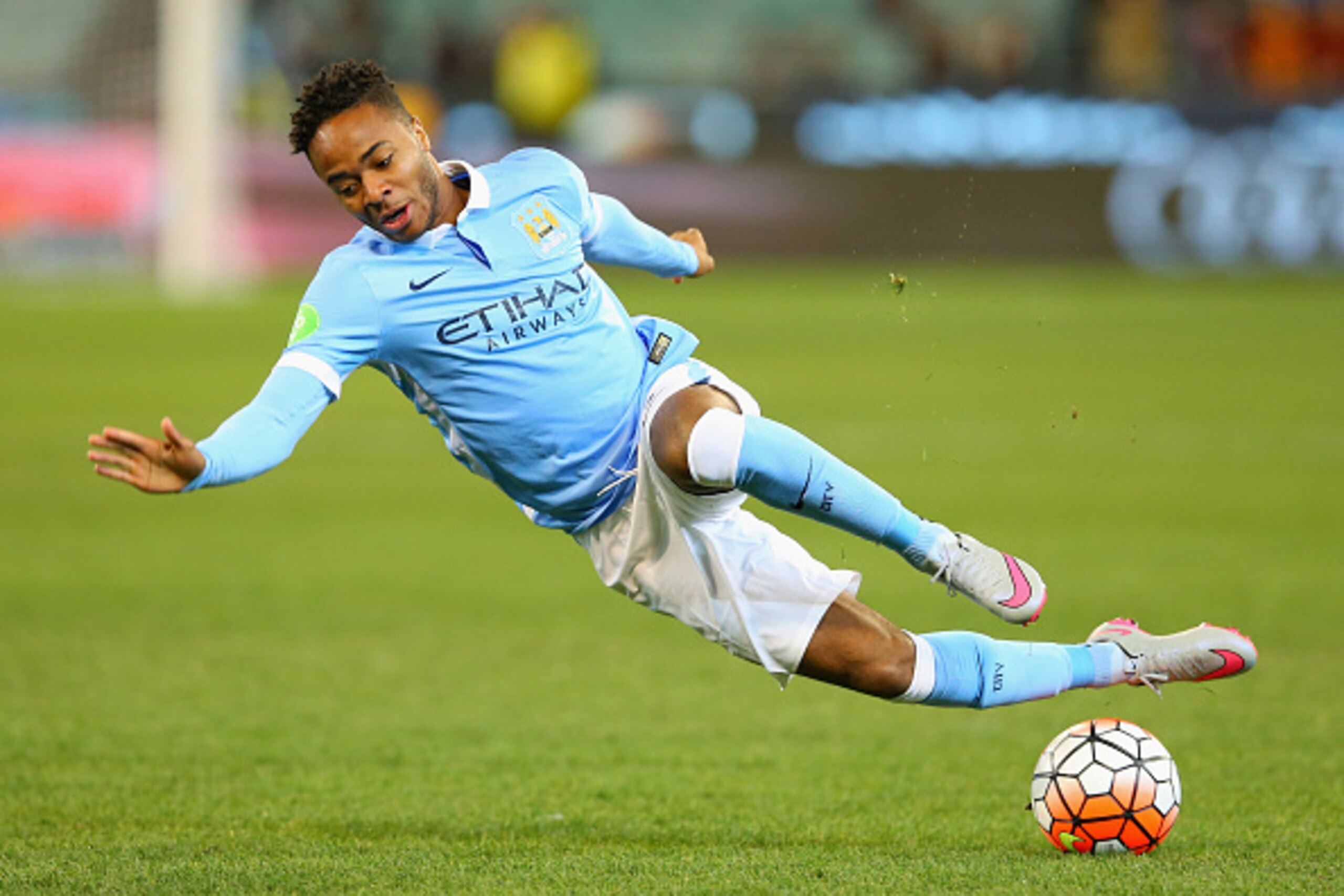 MELBOURNE, AUSTRALIA - JULY 21:  Raheem Sterling of Manchester City slips over whilst looking to pass the ball during the International Champions Cup friendly match between Manchester City and AS Roma at the Melbourne Cricket Ground on July 21, 2015 in Me