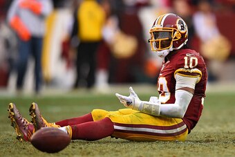 LANDOVER, MD - DECEMBER 28: Quarterback Robert Griffin III #10 of the Washington Redskins reacts after throwing a fourth quarter interception against the Dallas Cowboys at FedExField on December 28, 2014 in Landover, Maryland. The Dallas Cowboys won, 44-1