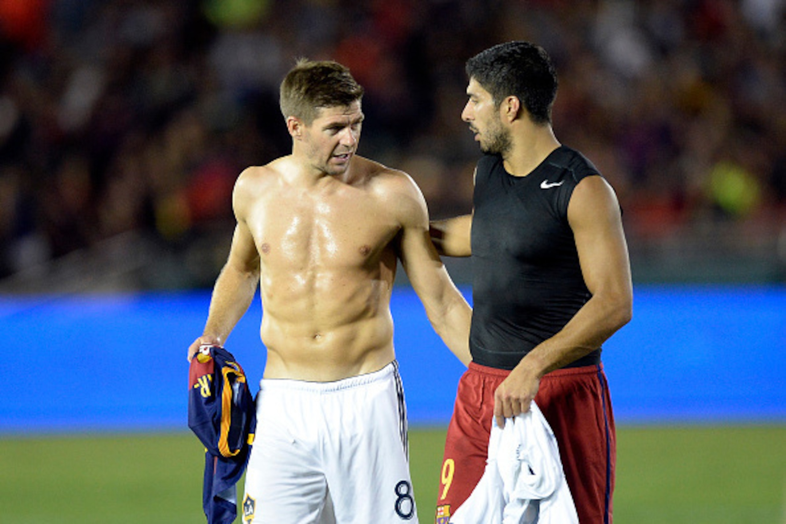 PASADENA, CA - JULY 21: Former Liverpool teammate Luis Suarez #9 of FC Barcelona and Steven Gerrard #8 of the Los Angeles Galaxy walk off the pitch after exchanging jerseys at halftime during International Champions Cup friendly soccer match at the Rose B