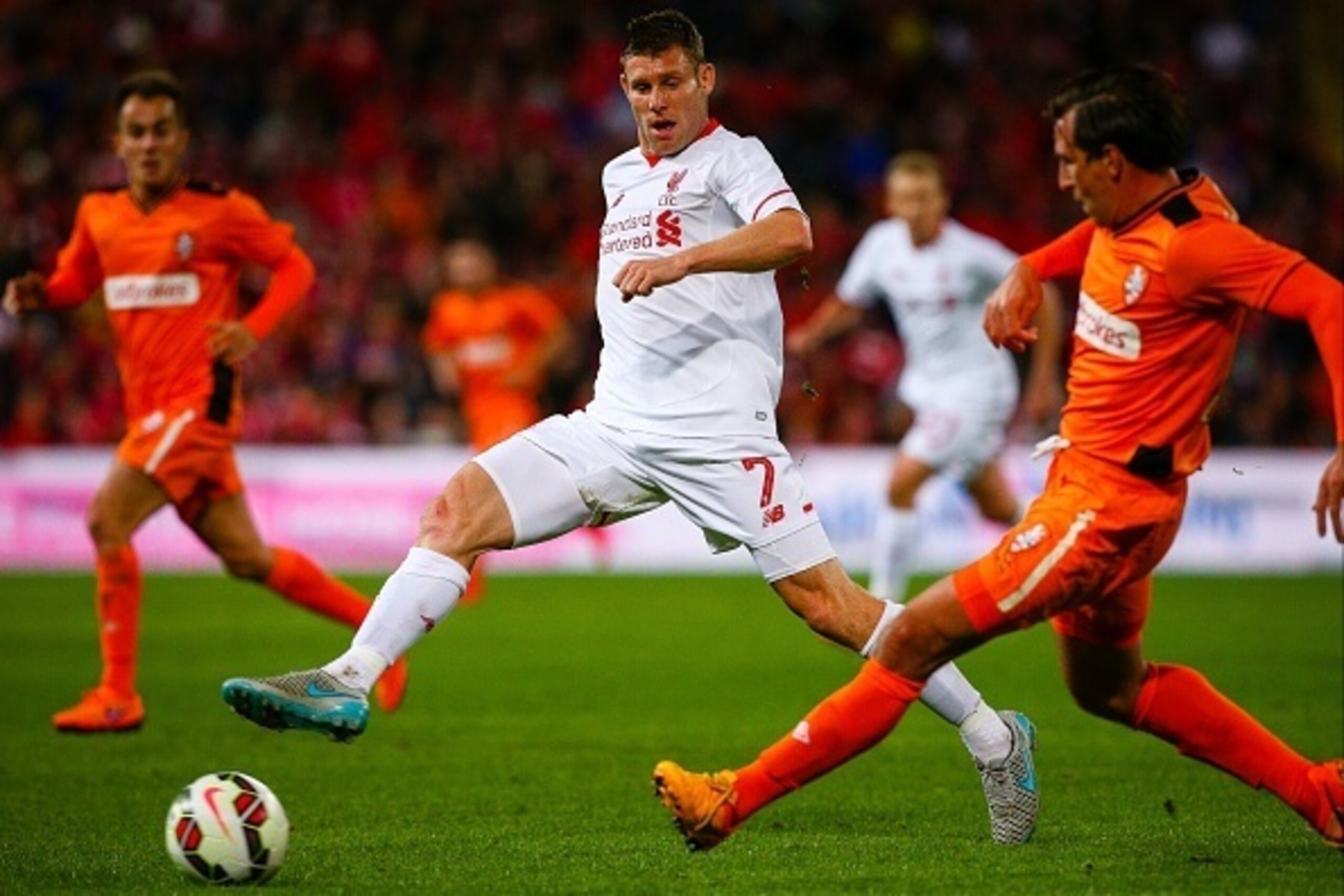 James Milner (L) of Liverpool fights for the ball with Shane Stefanutto (R) of the Brisbane Roar during the friendly football match between English Premier League side Liverpool and A-League side Brisbane Roar at Suncorp Stadium in Brisbane on July 17, 20