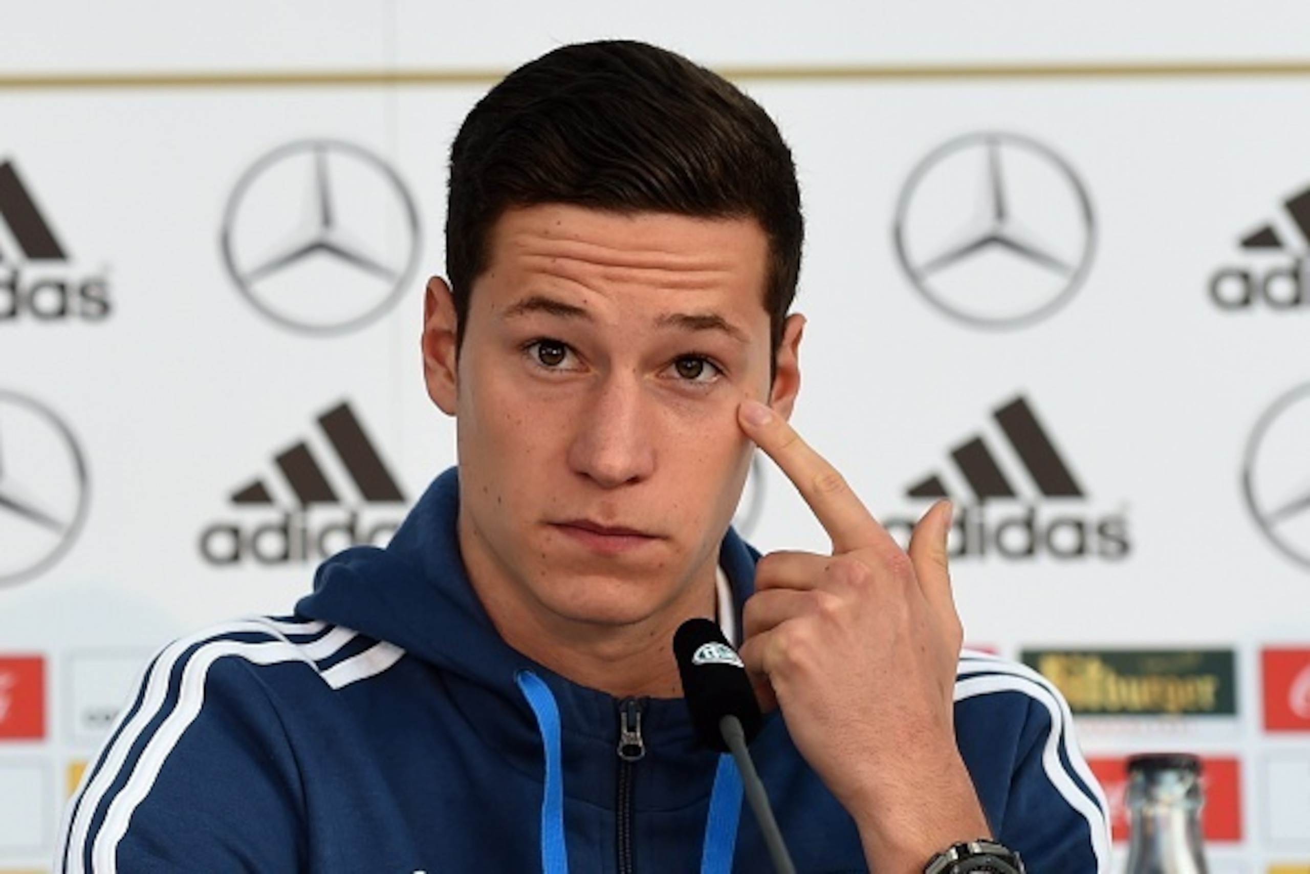 Germany's midfielder Julian Draxler listens to journalists' questions during a press conference of the German national football team in Essen, western Germany on October 13 , 2014, on the eve of the UEFA Euro 2016 qualifing game against Ireland. AFP PHOTO