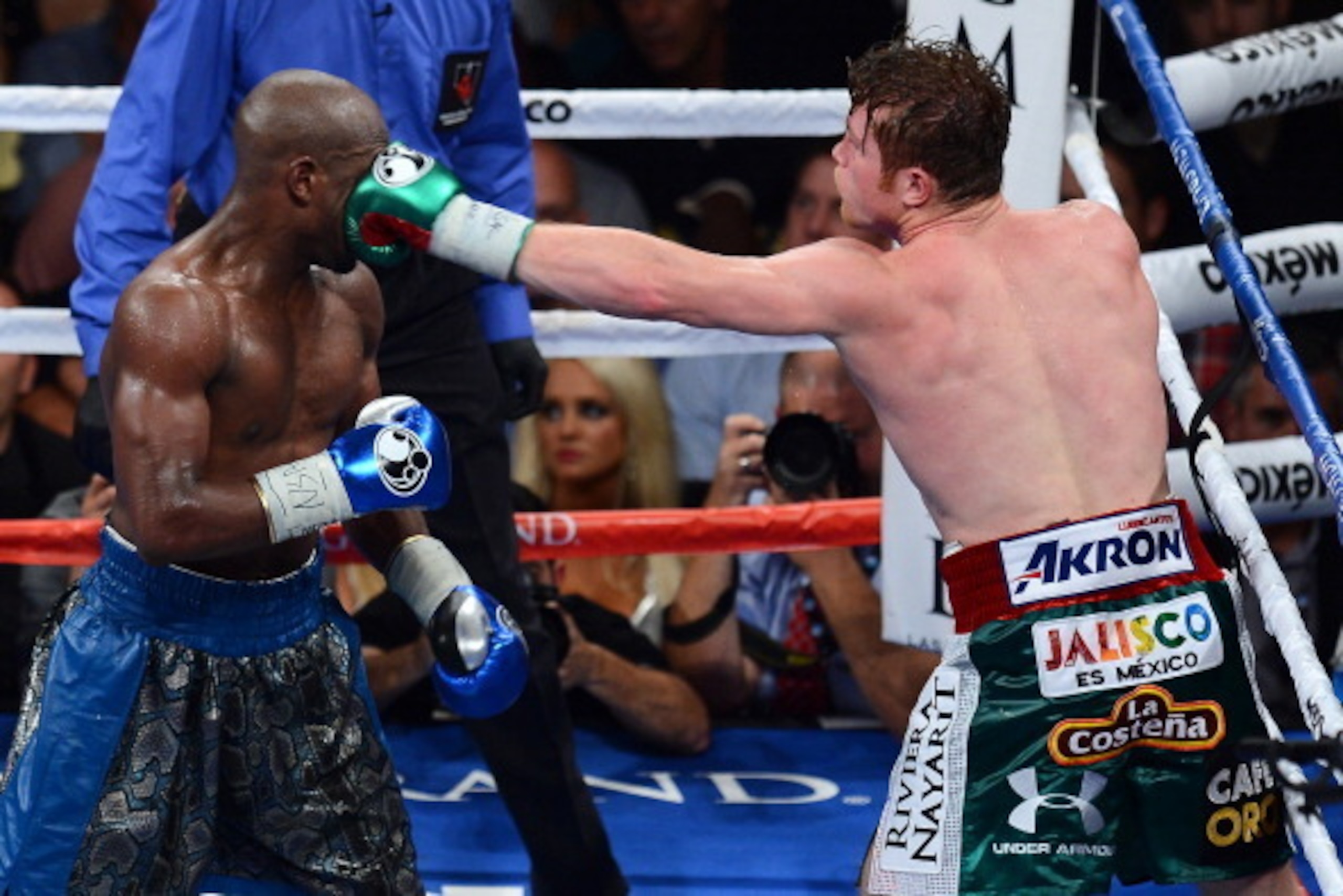 LAS VEGAS, NV - SEPTEMBER 14:  (R-L) Canelo Alvarez throws a left at Floyd Mayweather Jr. during their WBC/WBA 154-pound title fight at the MGM Grand Garden Arena on September 14, 2013 in Las Vegas, Nevada.  (Photo by Ethan Miller/Getty Images)
