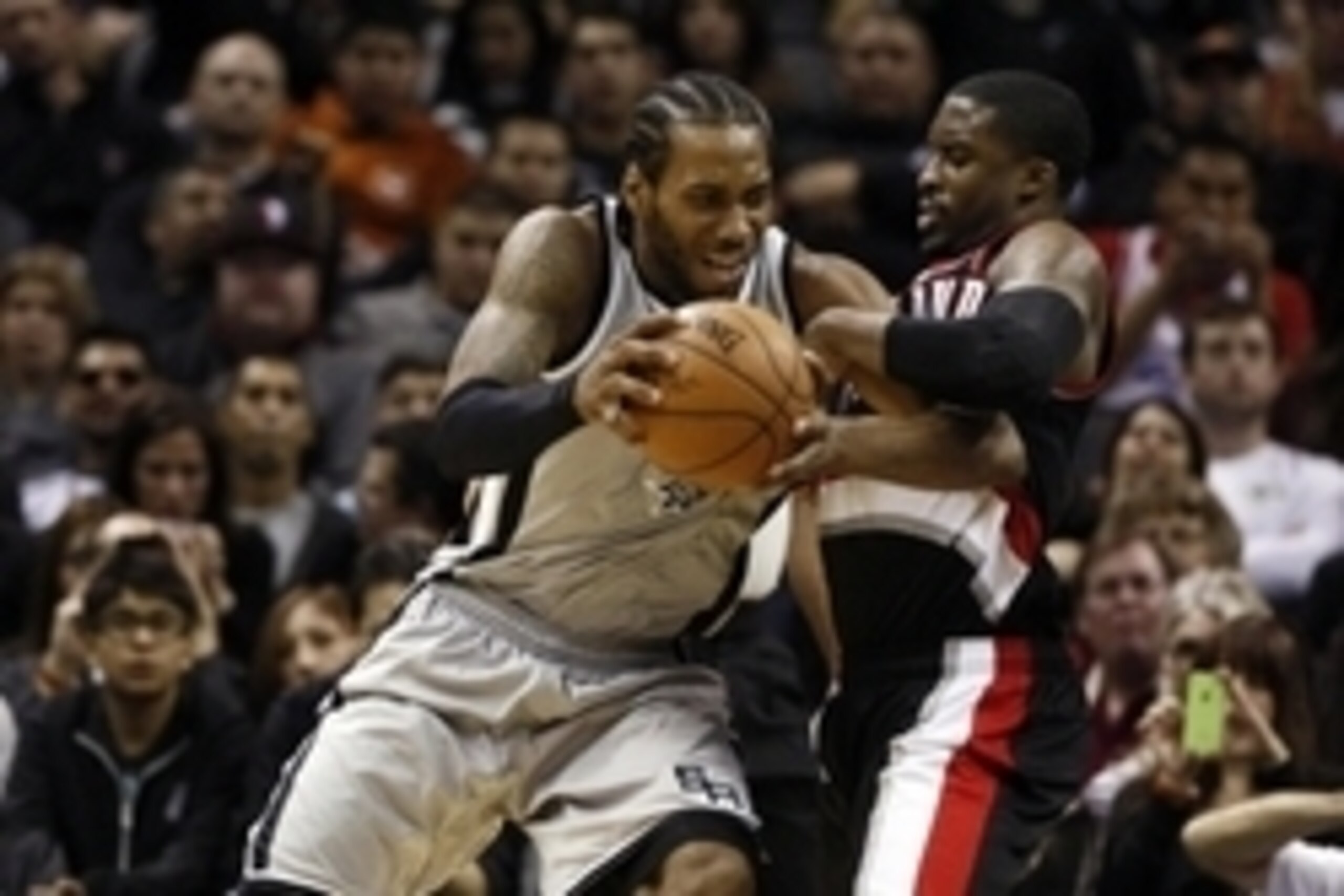 Jan 16, 2015; San Antonio, TX, USA; San Antonio Spurs small forward Kawhi Leonard (2) is fouled by Portland Trail Blazers shooting guard Wesley Matthews (2, R) during the second half at AT&T Center. Mandatory Credit: Soobum Im-USA TODAY Sports