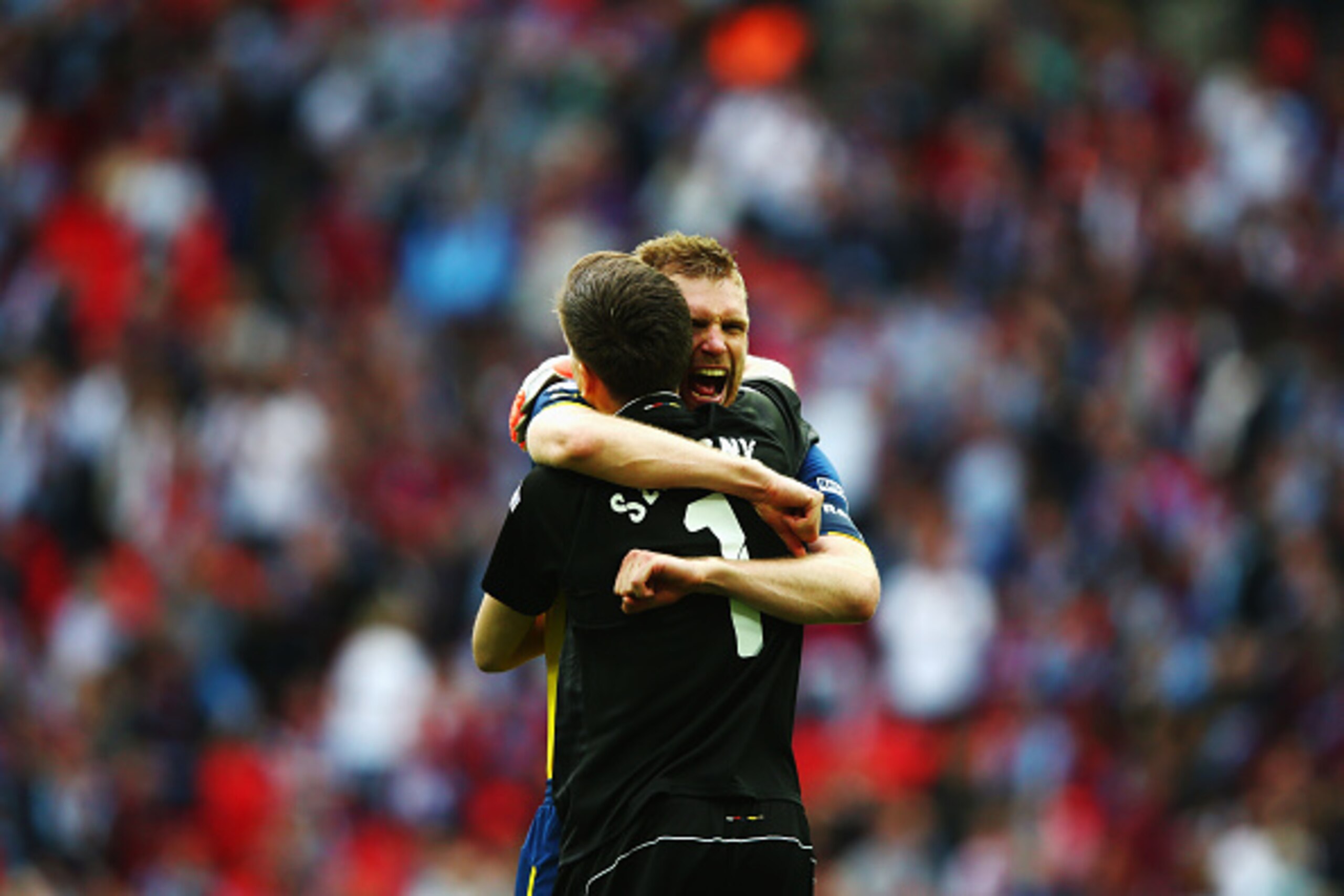 LONDON, ENGLAND - MAY 30:  Per Mertesacker of Arsenal celebrates victory with Wojciech Szczesny after the FA Cup Final between Aston Villa and Arsenal at Wembley Stadium on May 30, 2015 in London, England. Arsenal beat Aston Villa 4-0.  (Photo by Clive Ro