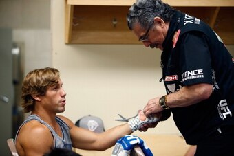 LAS VEGAS, NV - JULY 05:  Urijah Faber (L) gets his hands wrapped by cutman Jacob 'Stitch' Duran inside the locker room at UFC 175 inside the Mandalay Bay Events Center on July 5, 2014 in Las Vegas, Nevada.  (Photo by Esther Lin/Zuffa LLC/Zuffa LLC via Ge