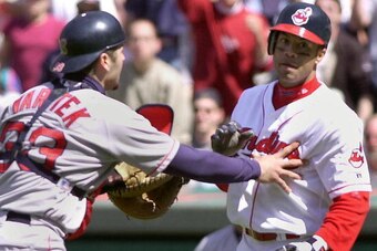 CLEVELAND, UNITED STATES:  Cleveland Indians batter Roberto Alomar (R) is restrained by Boston Red Sox catcher Jason Varitek after Alomar was hit by a Pedro Martinez pitch in the eighth inning 30 April 2000 at Jacobs Field in Cleveland, OH. Martinez was e