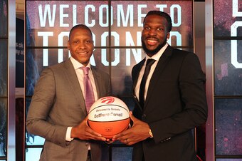 TORONTO, CANADA - JULY 9:  Masai Ujiri, GM of the Toronto Raptors, introduces DeMarre Carroll during a press conference on July 9, 2015 at the Air Canada Centre in Toronto, Ontario, Canada.  NOTE TO USER: User expressly acknowledges and agrees that, by do
