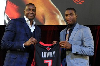 TORONTO, ON - JULY 10:  Masai Ujiri and Kyle Lowry during the press conference after his singing of a contract extension with the Toronto Raptors at the Air Canada Centre on July 10, 2014 in Toronto, Ontario, Canada. NOTE TO USER: User expressly acknowled