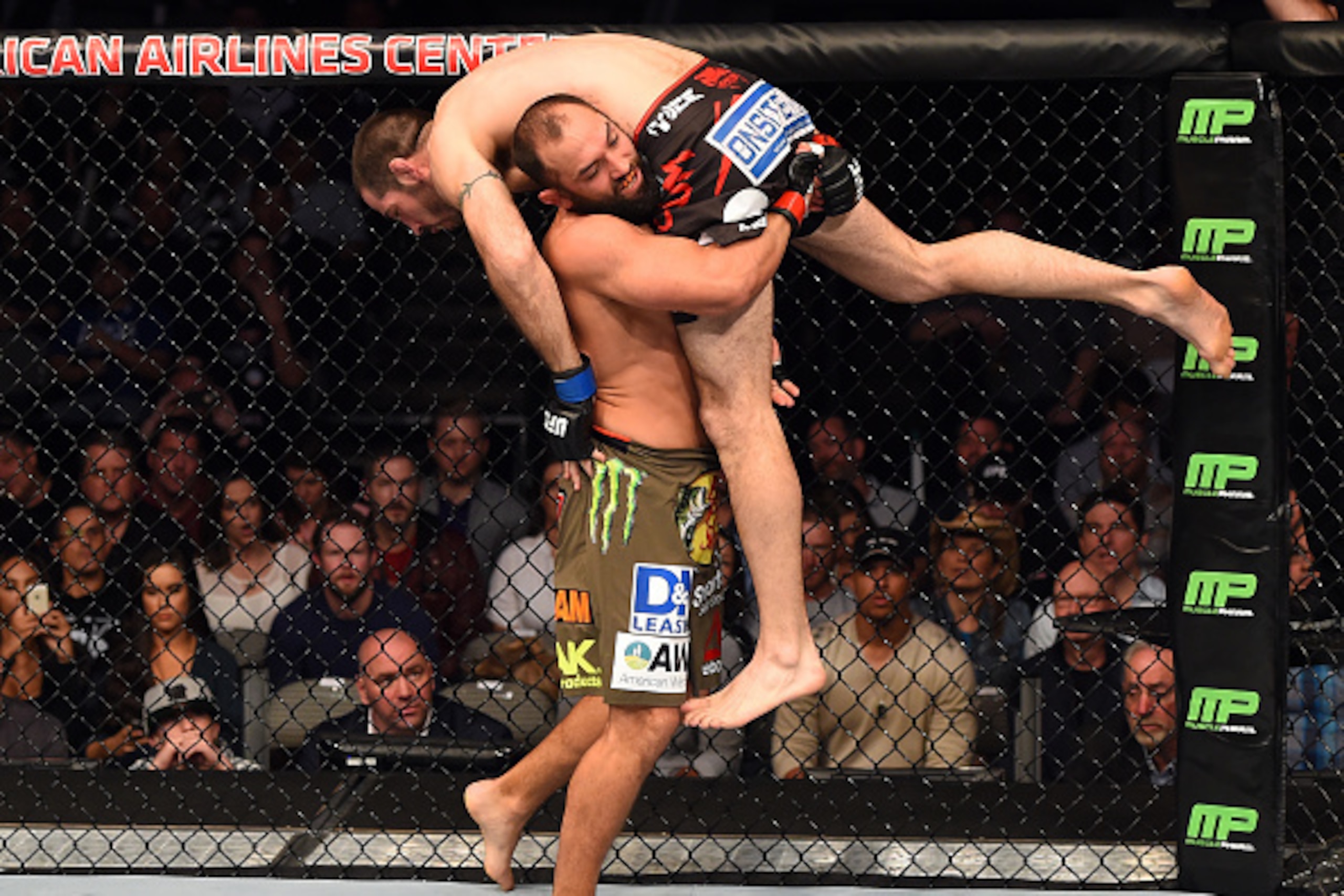 DALLAS, TX - MARCH 14:  (L-R) Johny Hendricks takes down Matt Brown in their welterweight bout during the UFC 185 event at the American Airlines Center on March 14, 2015 in Dallas, Texas. (Photo by Josh Hedges/Zuffa LLC/Zuffa LLC via Getty Images)