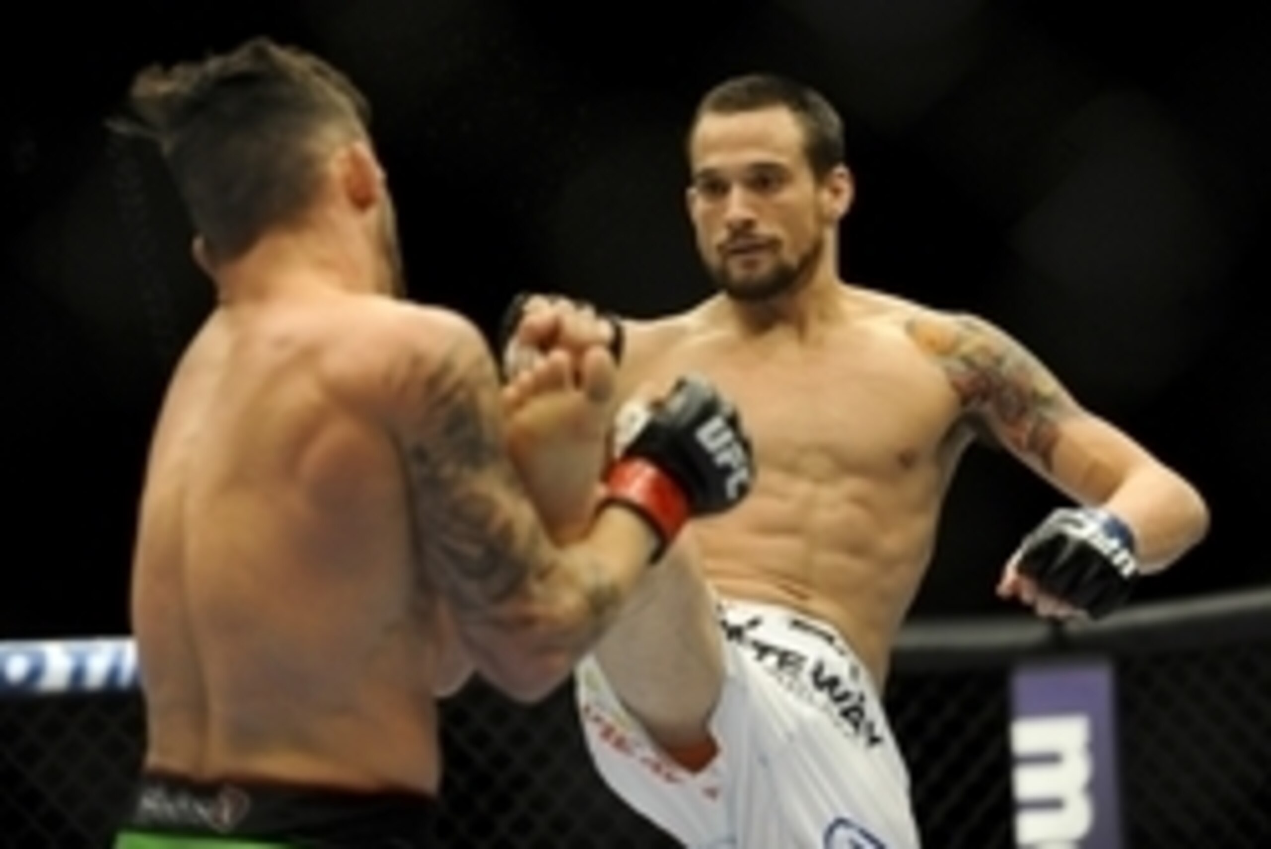 May 24, 2014; Las Vegas, NV, USA; James Krause (blue) throws a kick at Jamie Varner (red) during their UFC 173 bantamweight bout at MGM Grand Garden Arena. Krause won his bout by TKO.  Mandatory Credit: Stephen R. Sylvanie-USA TODAY Sports