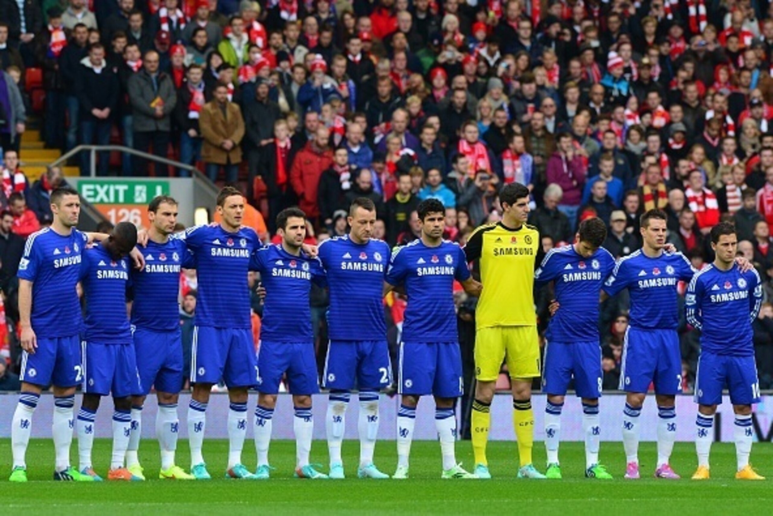 Chelsea's starting XI observe a minute's silence in honour of the up-coming Remembrance Day ahead of kick off of the English Premier League football match between Liverpool and Chelsea at Anfield in Liverpool, north west England on November 8, 2014. AFP P