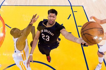 OAKLAND, CA - APRIL 20: Anthony Davis #23 of the New Orleans Pelicans goes in for a layup over Draymond Green #23 and Andrew Bogut #12 of the Golden State Warriors in the third second half during the first round of the 2015 NBA Playoffs at ORACLE Arena on