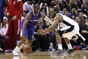 SAN ANTONIO, TX - APRIL 30: Chris Paul #3 of the Los Angeles Clippers drives around Kawhi Leonard #2 of the San Antonio Spurs during Game Six of the Western Conference quarterfinals of the 2015 NBA Playoffs at the AT&T Center on April 30, 2015 in San Anto