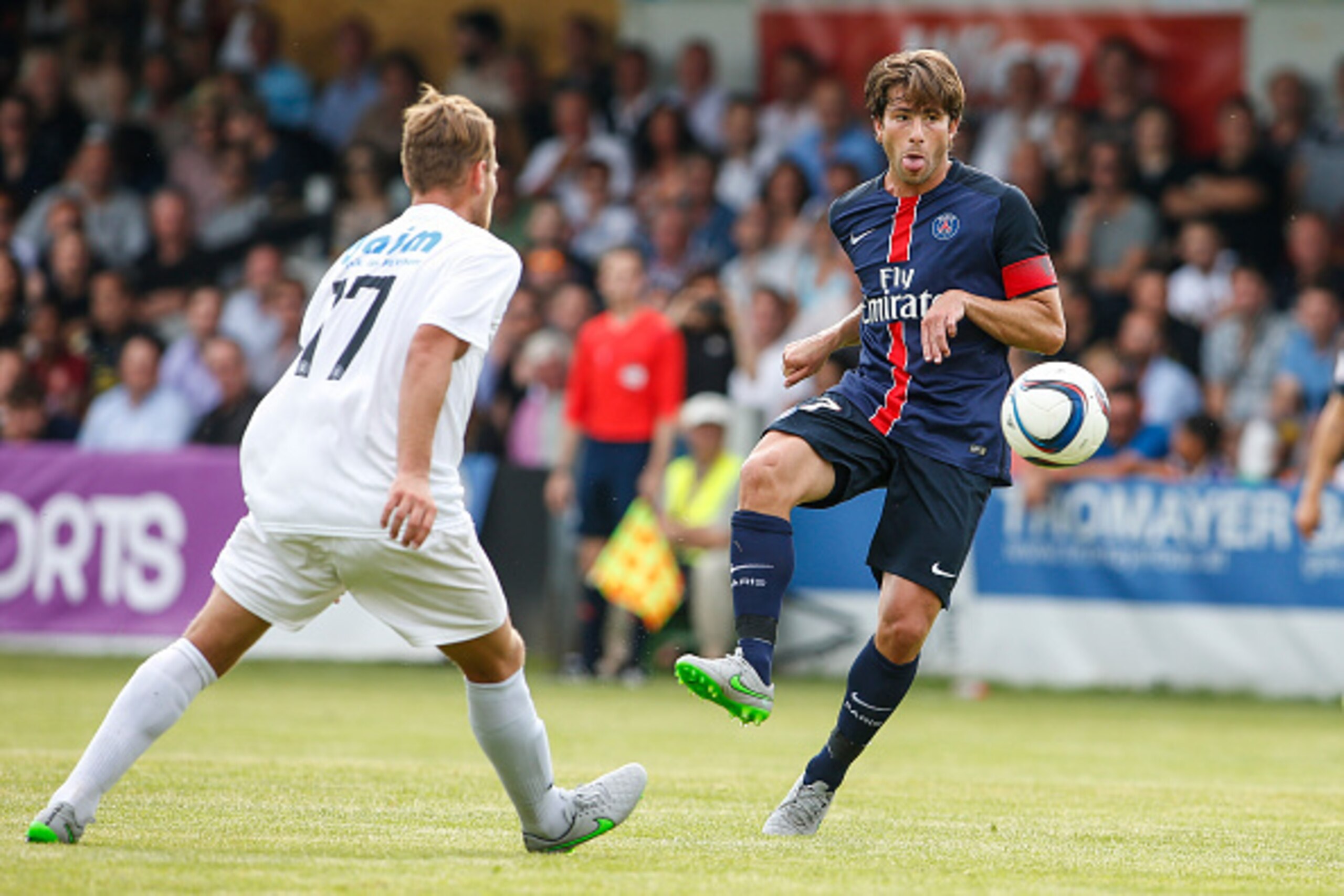 VIENNA, AUSTRIA - JULY 12:  Philip Dimov of Wiener Sportklub (L) competes for the ball with Maxwell Scherrer Cabelino Andrade of Paris Saint-Germain during the Friendly Match between Wiener Sportklub and Paris Saint-Germain at Sportclub Platz on July 12, 