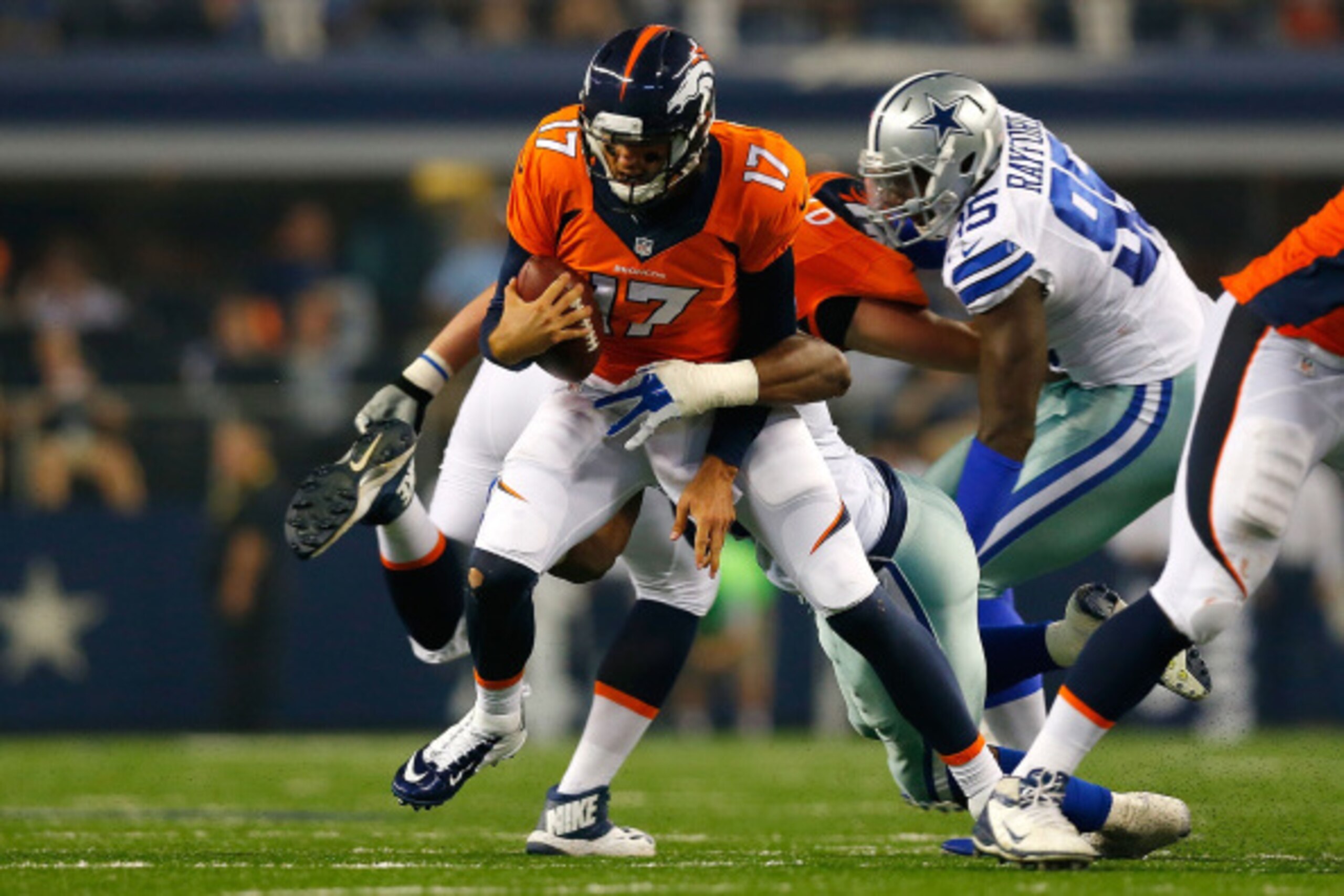 ARLINGTON, TX - AUGUST 28: Brock Osweiler #17 of the Denver Broncos is sacked by L.P. Ladouceur #91 of the Dallas Cowboys in the first half of their preseason game at AT&T Stadium on August 28, 2014 in Arlington, Texas. (Photo by Tom Pennington/Getty Im ARLINGTON, TX - AUGUST 28: Brock Osweiler #17 of the Denver Broncos is sacked by L.P. Ladouceur #91 of the Dallas Cowboys in the first half of their preseason game at AT&T Stadium on August 28, 2014 in Arlington, Texas. (Photo by Tom Pennington/Getty Im