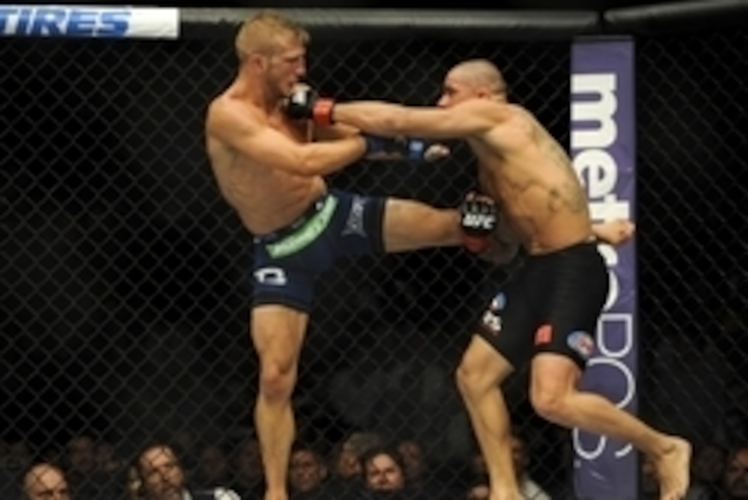May 24, 2014; Las Vegas, NV, USA;  Renan Barao (red) takes a kick from TJ Dillashaw (blue) during their UFC 173 bantamweight championship bout at MGM Grand Garden Arena. Dillashaw won the bout by way of TKO. Mandatory Credit: Stephen R. Sylvanie-USA TODAY