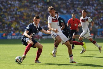 RIO DE JANEIRO, BRAZIL - JULY 04: Laurent Koscielny of France in action with Thomas Muller of Germany during the 2014 FIFA World Cup Brazil Quarter Final match between France and Germany at Maracana Stadium on July 04, 2014 in Rio de Janeiro, Brazil.  (Ph