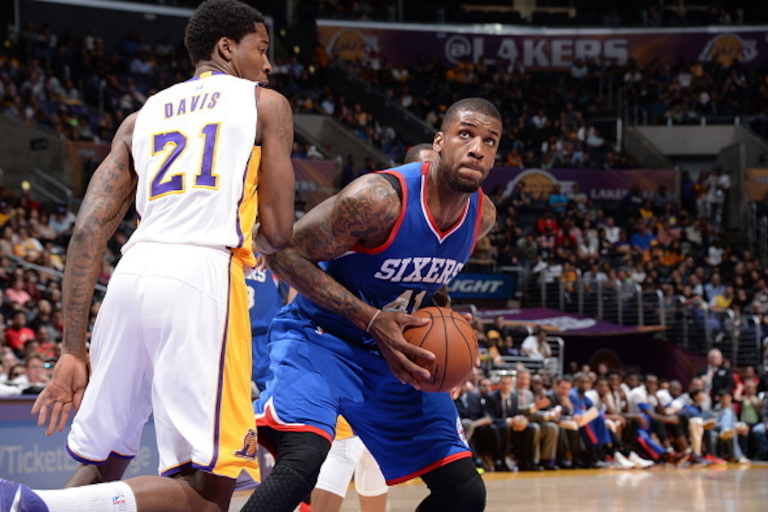 LOS ANGELES, CA - MARCH 22:  Thomas Robinson #41 of the Philadelphia 76ers handles the ball against Ed Davis #21 of the Los Angeles Lakers on March 22, 2015 at Staples Center in Los Angeles, California. NOTE TO USER: User expressly acknowledges and agrees