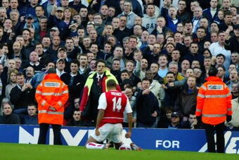 LONDON - NOVEMBER 16:  Thierry Henry of Arsenal celebrates his goal in front of the Tottenham Hotspur fans during the FA Barclaycard Premiership match between Arsenal and Tottenham Hotspur on November 16, 2002 played at Highbury in London, England. Arsena