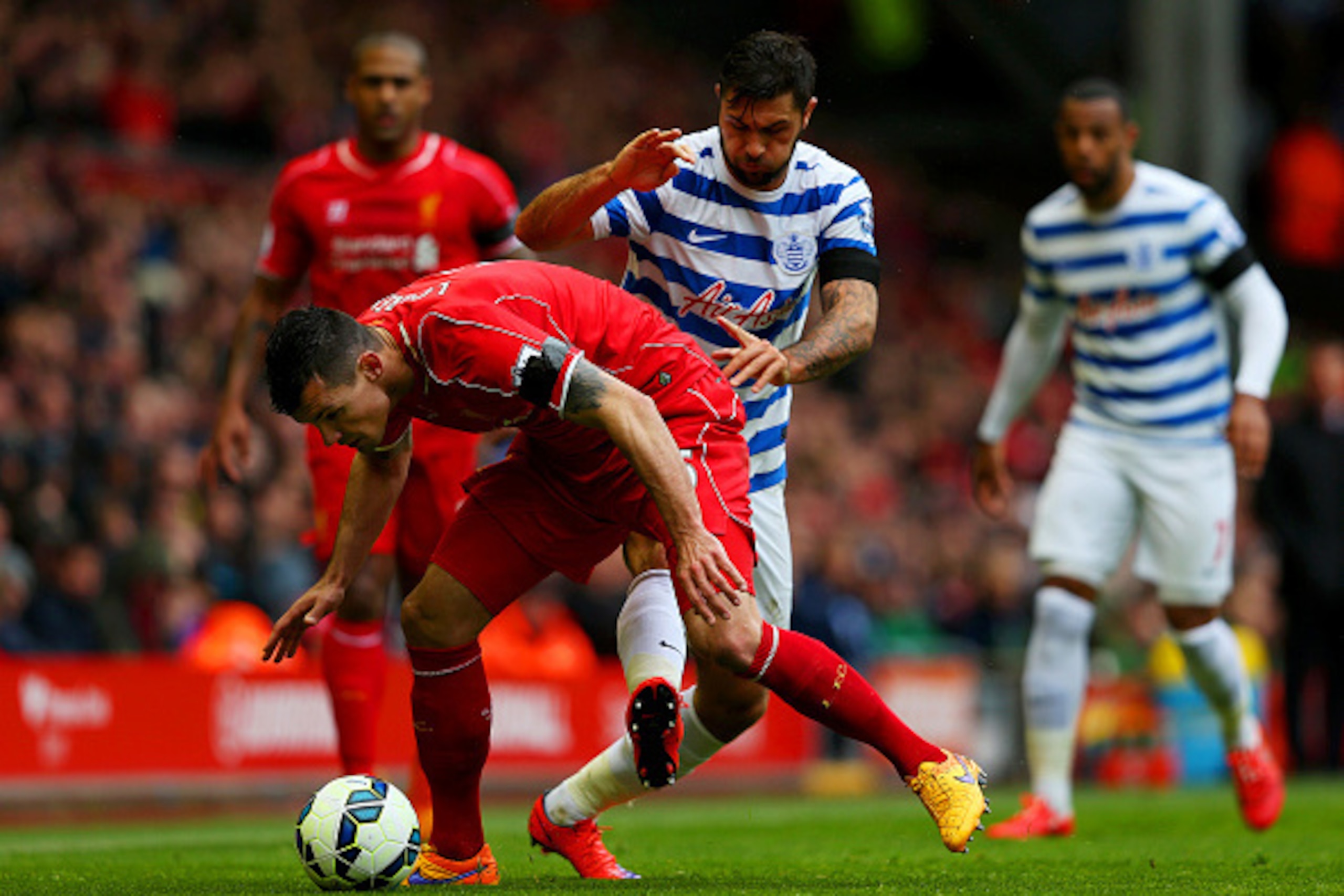 LIVERPOOL, ENGLAND - MAY 02: Charlie Austin of QPR challenges Dejan Lovren of Liverpool during the Barclays Premier League match between Liverpool and Queens Park Rangers at Anfield on May 2, 2015 in Liverpool, England.  (Photo by Alex Livesey/Getty Image